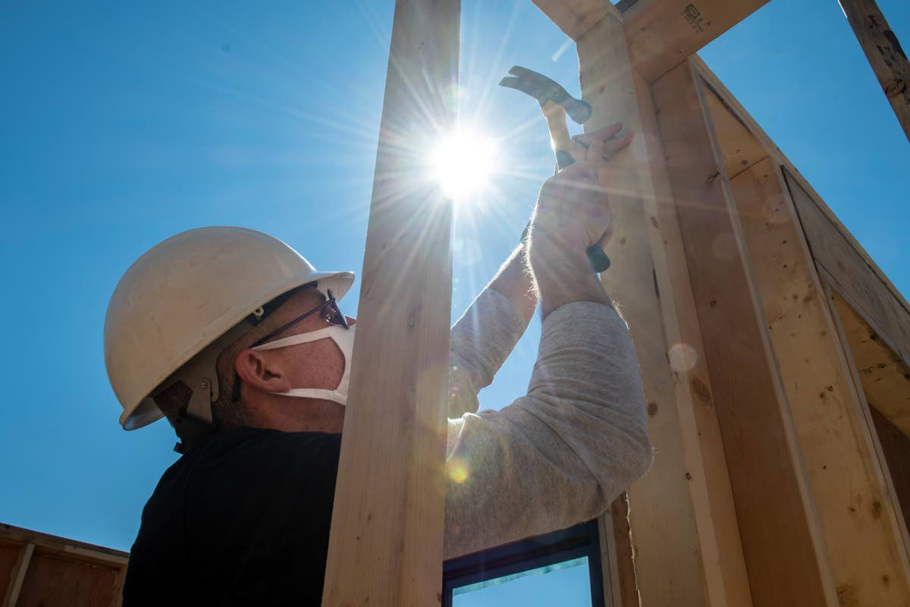 Director Ryan Smith, of Washington State University’s School of Design and Construction, hammers a nail into the final wall of an energy efficient house in Uniontown on Thursday afternoon.