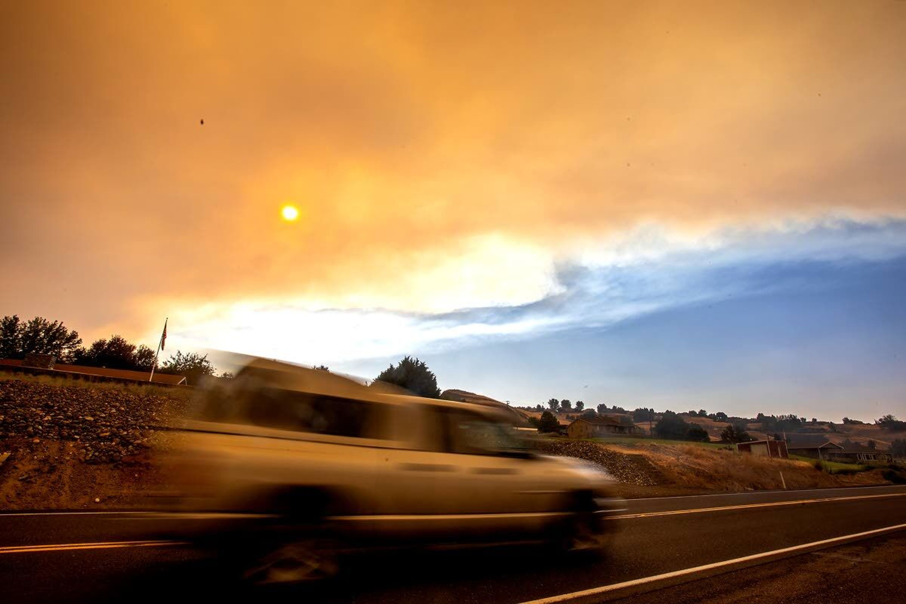 A car moves down U.S. Highway 129 towards Clarkston as smoke flows over the Lewis-Clark Valley on Saturday.