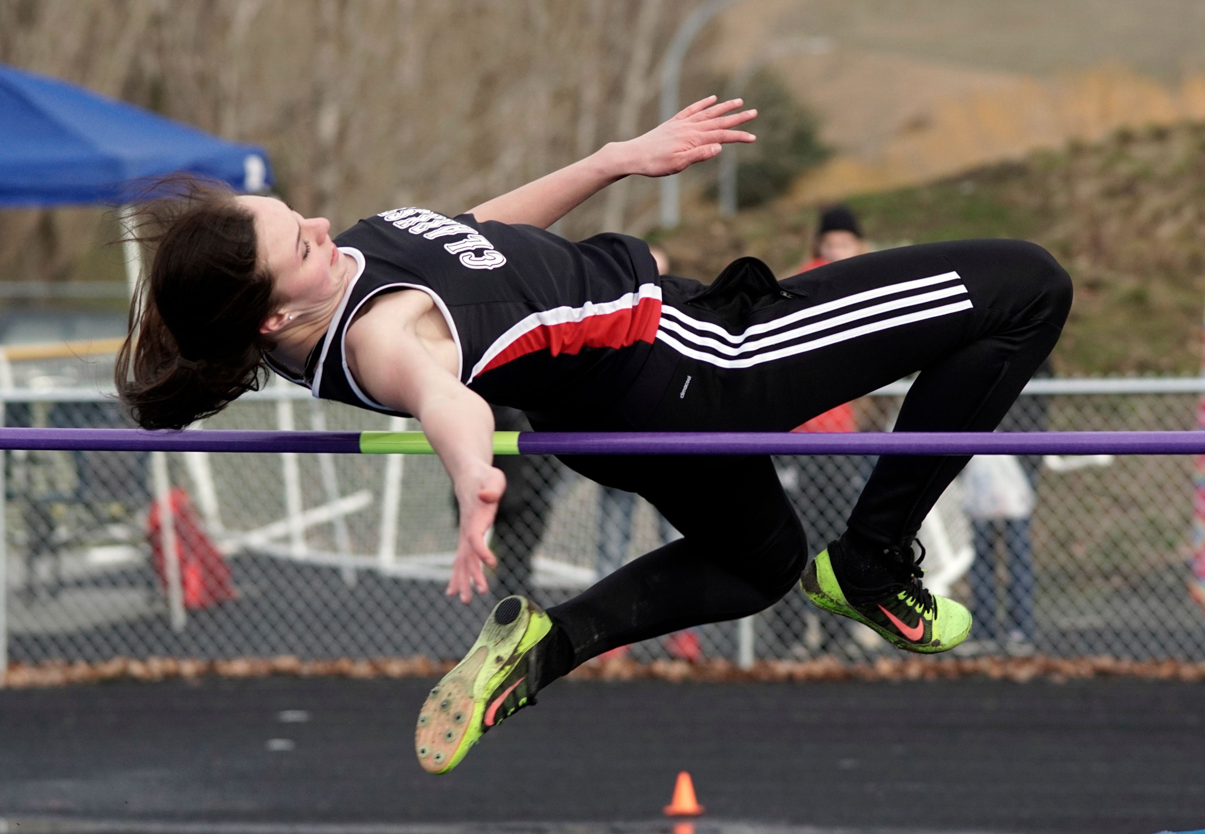 Clarkston's AJ Sobotta shows her form while trying to clear the bar in the high jump during a dual meet at Pullman on Wednesday afternoon.