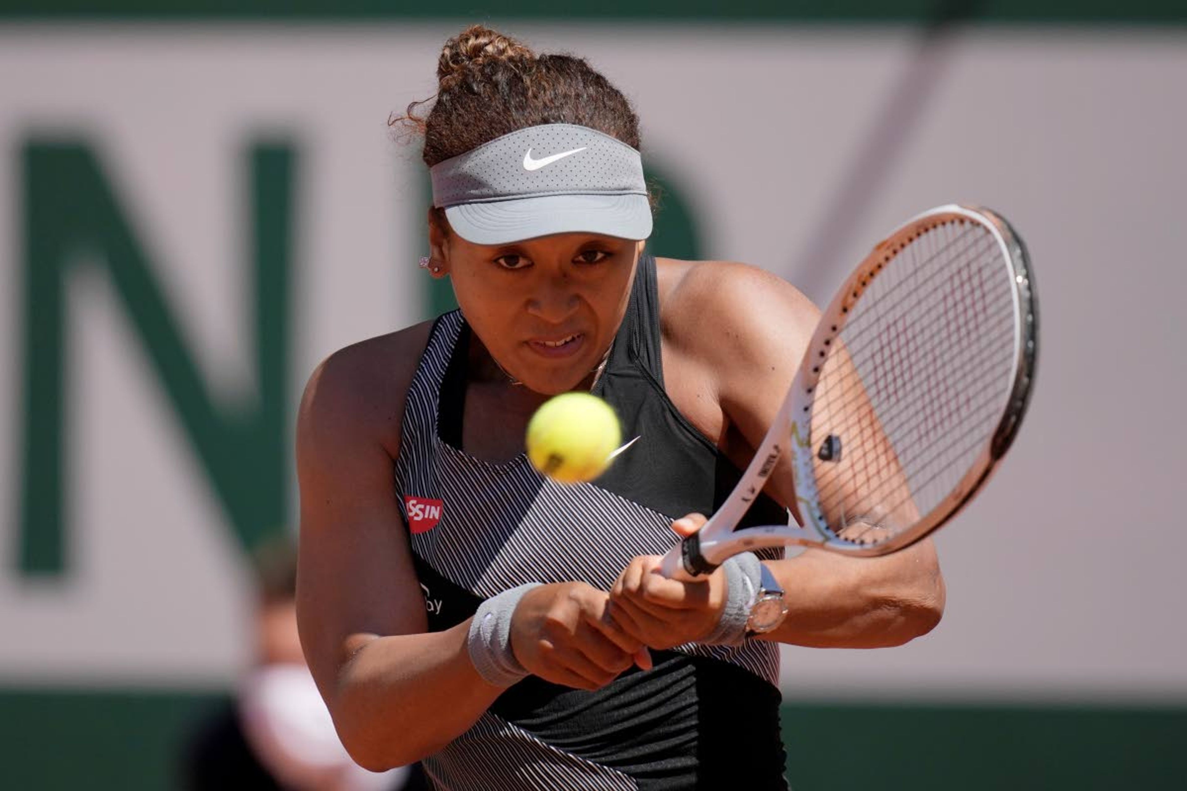 Associated PressJapan’s Naomi Osaka returns the ball to Romania’s Patricia Maria Tig during their first round match of the French Open tournament at the Roland Garros stadium Sunday in Paris.