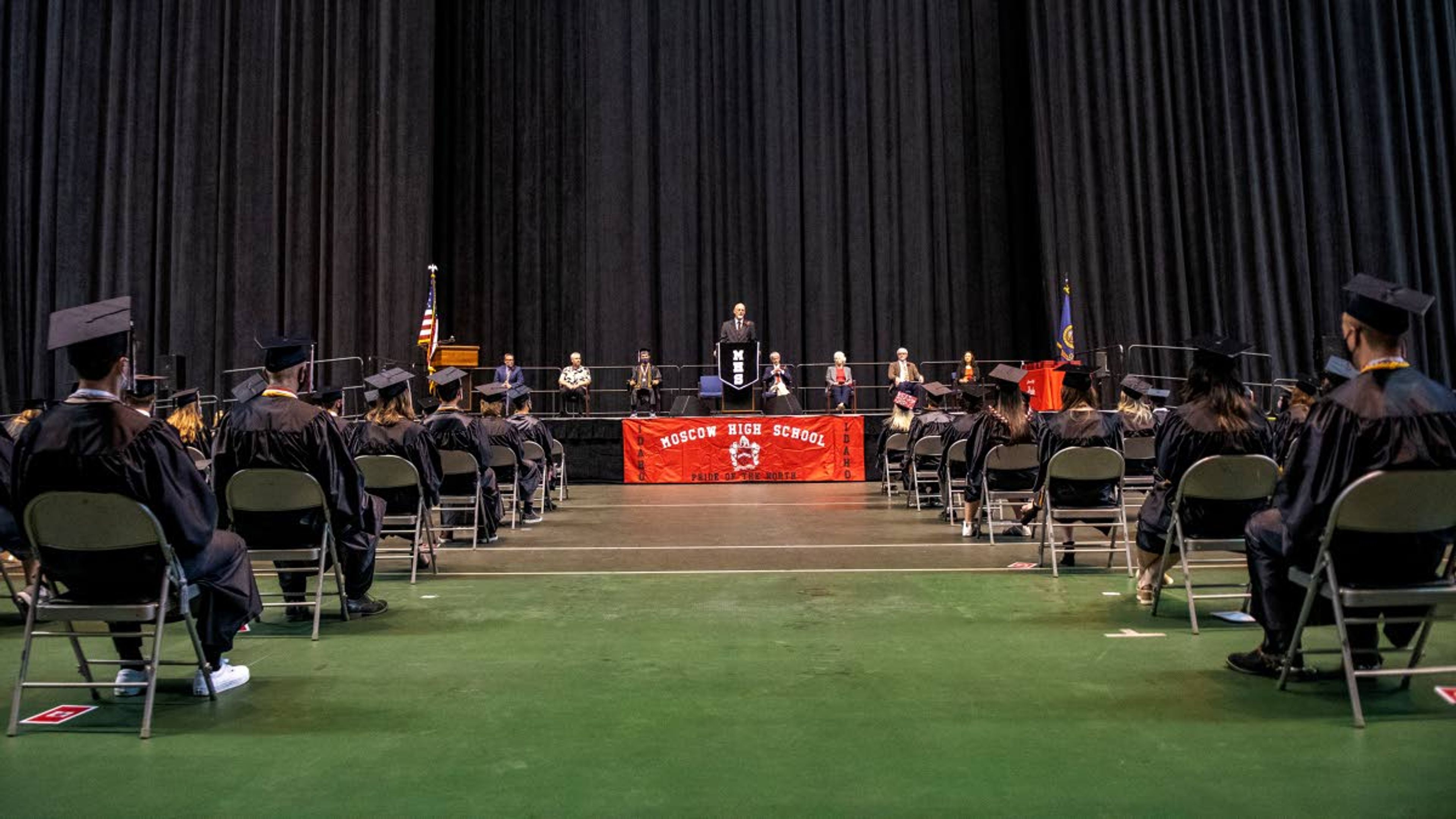 Moscow High School’s graduating Class of 2021 listens to Superintendent Greg Bailey’s opening statement during their graduation commencement at the University of Idaho’s Kibbie Dome on Friday night.