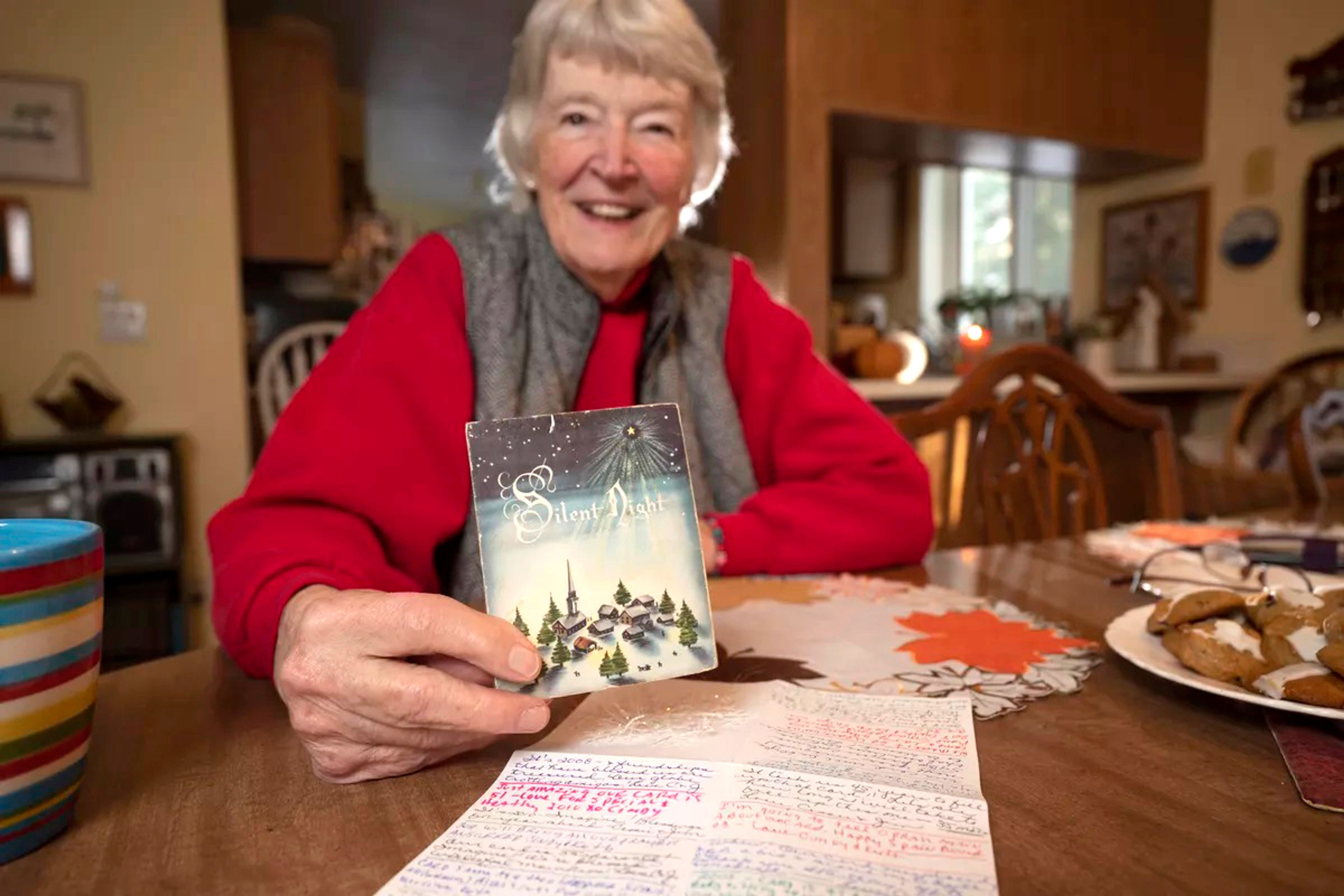 Cassie Hill, of Deer Park, holds the Christmas card she and a friend have been sending back and forth to each other for 65 years.