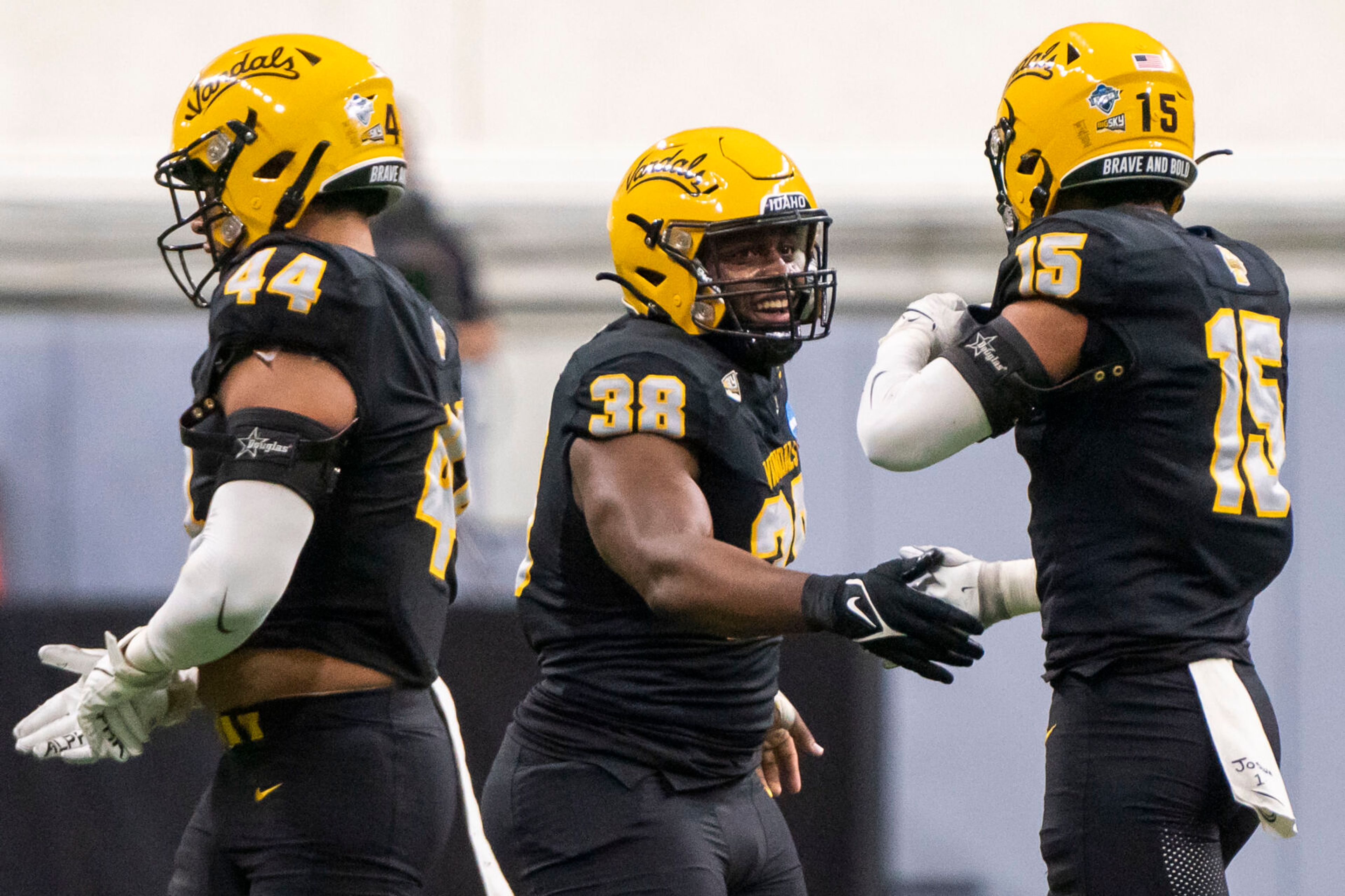 Idaho Vandals defensive lineman Tylen Coleman (38) high-fives defensive lineman Malakai Williams (15) during their game against Albany in the third round of the 2023 Division I FCS Football Championship on Saturday inside the Kibbie Dome in Moscow.