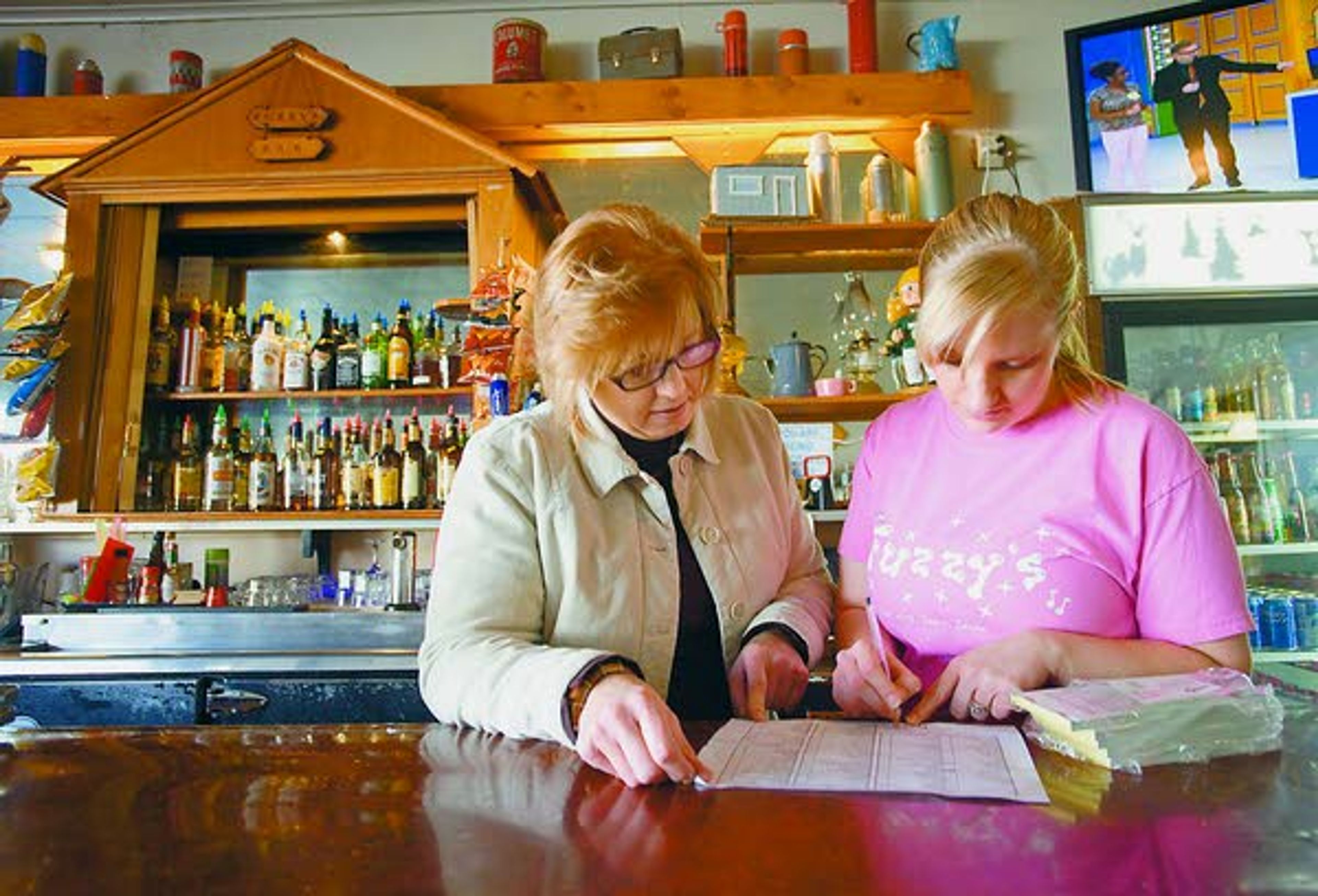 Dellrae Warner, left, and Kelsey Sutton review a list of supplies to order Friday at Fuzzy’s in Deary. Warner and her husband, Greg Warner, have owned Fuzzy’s since 2010.