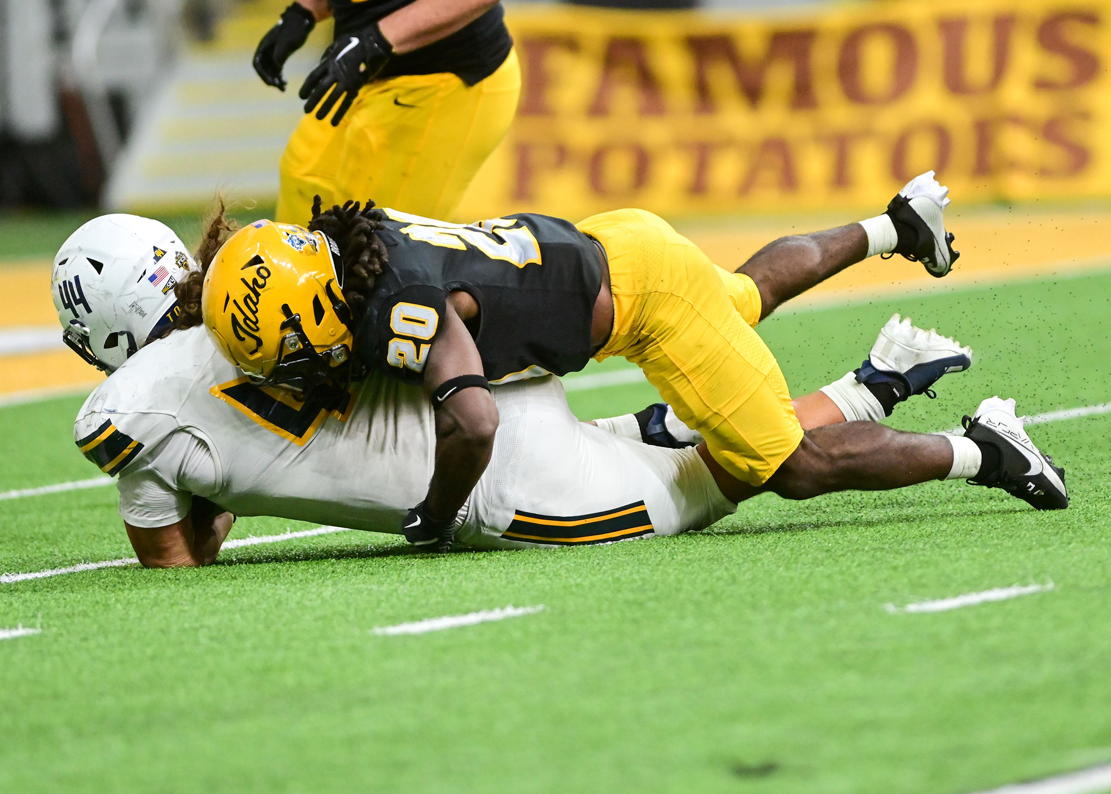 Idaho running back Elisha Cummings tackles Northern Arizona defensive lineman Tausagafou Ho Ching after Northern Arizona took control of the ball during an Idaho play Saturday at the P1FCU Kibbie Dome in Moscow.,