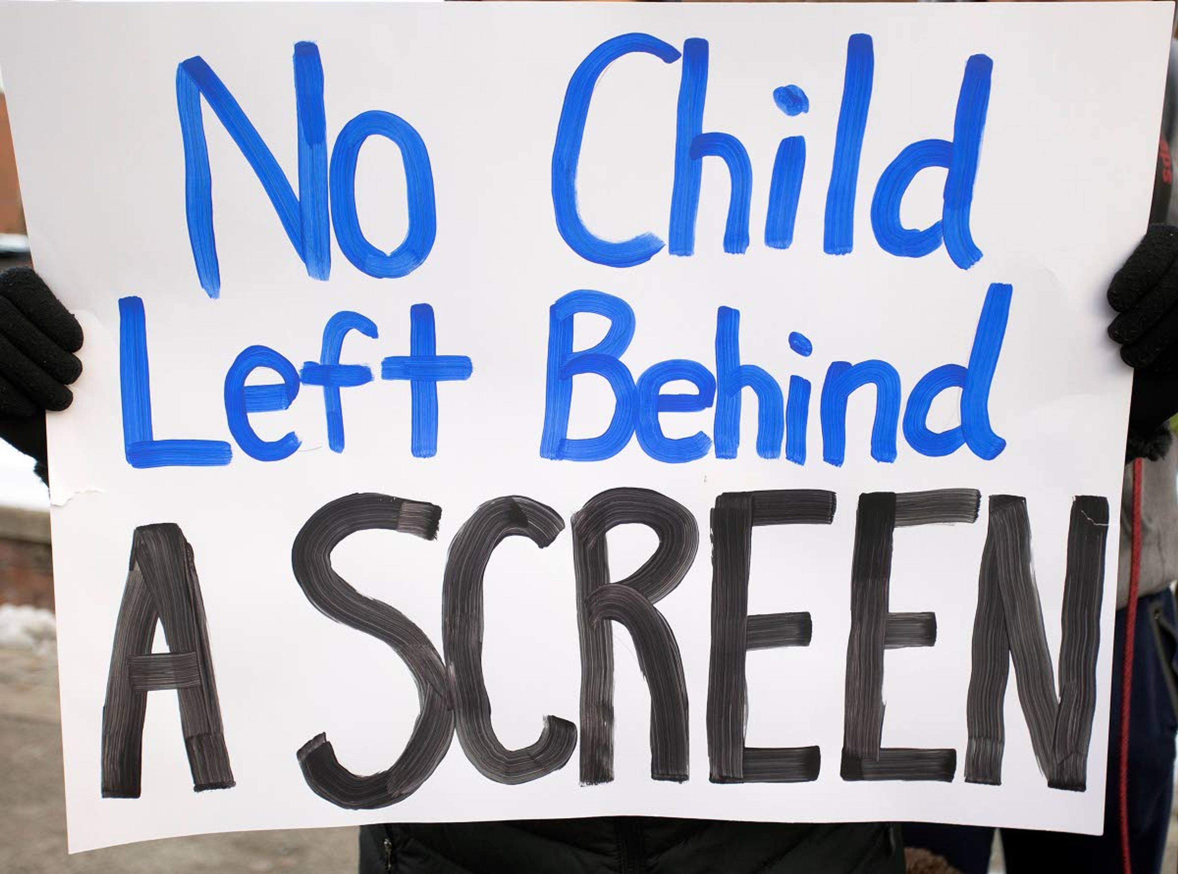 A Pullman High School student holds a sign during a demonstration urging the school board to transition to in-person classes as soon as possible Monday in Pullman.