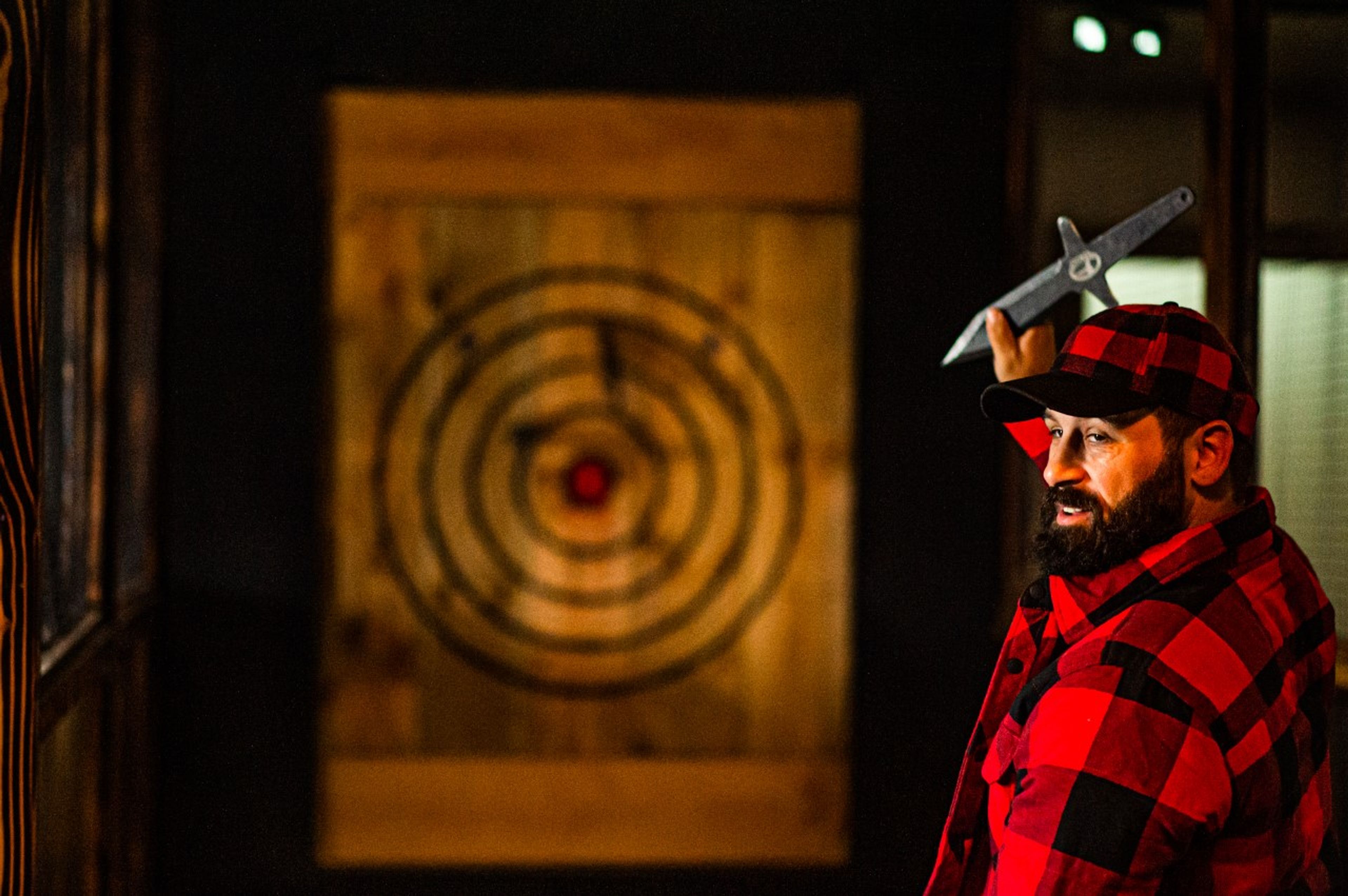 Chris Ihler, an owner of Moscow Axe Throwing, aims a knife at a target at his business, at 310 W. Third St.