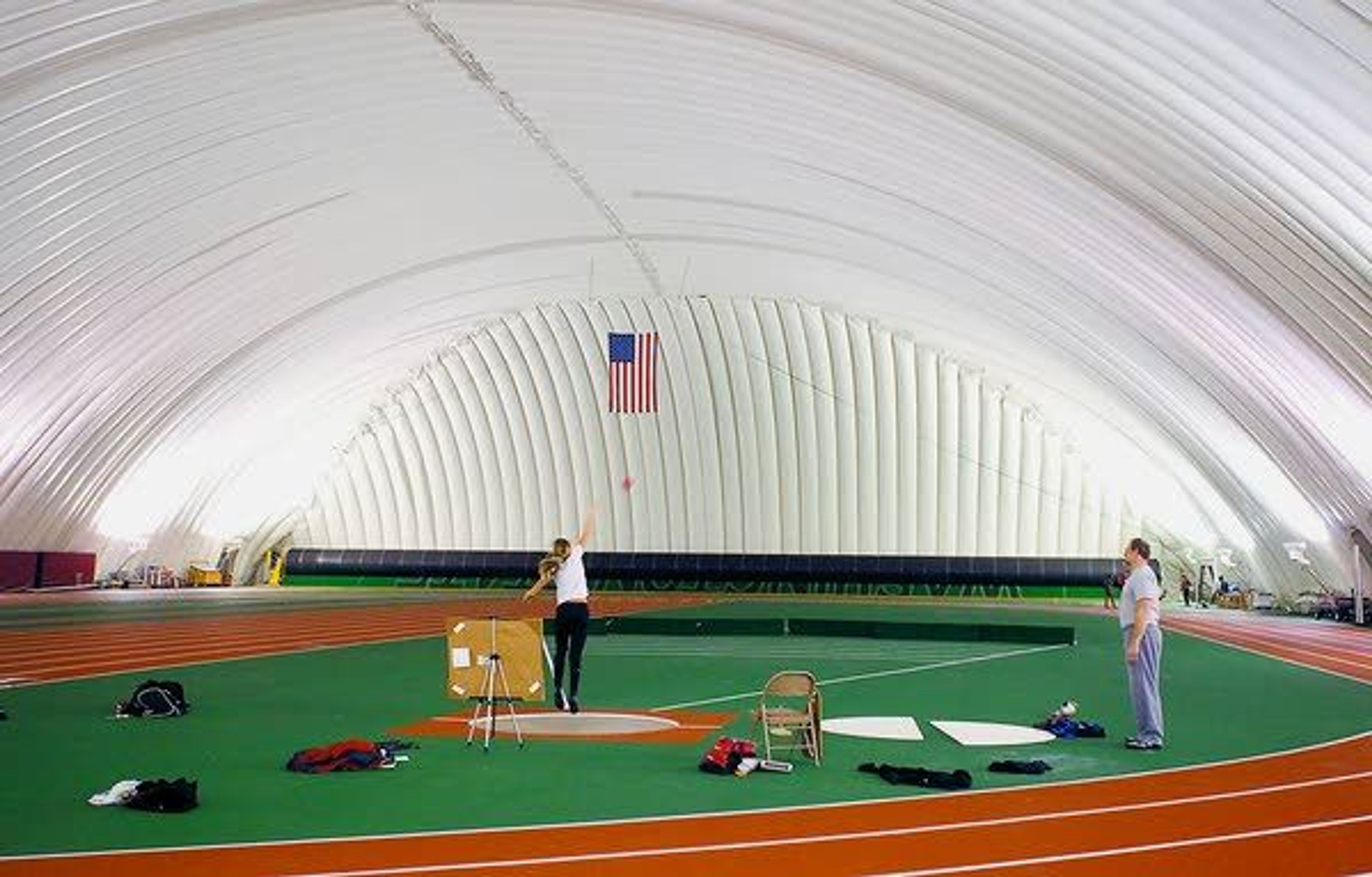 Members of the Washington State University track and field team practice Wednesday in the Indoor Practice Facility in Pullman. The university has proposed replacing the building.