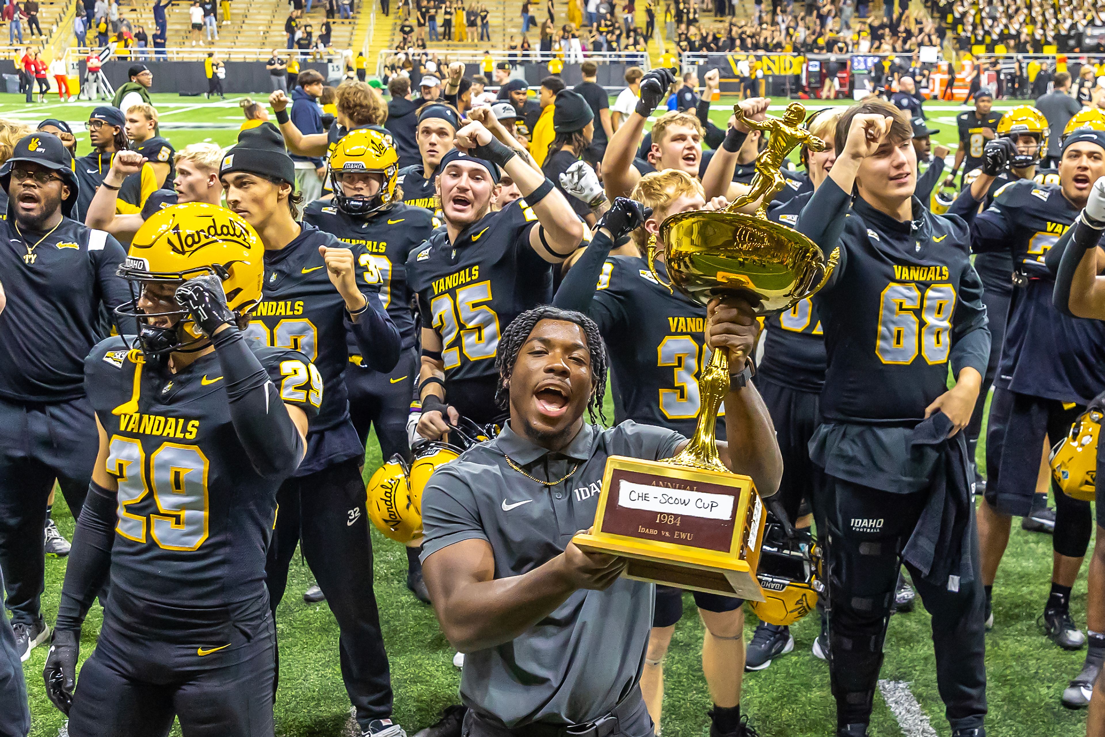 Idaho sings their fight song as they hoist the �Che-Scow cup� trophy after defeating Eastern Washington 38-28 during a Big Sky game Saturday at the Kibbie Dome in Moscow. ,