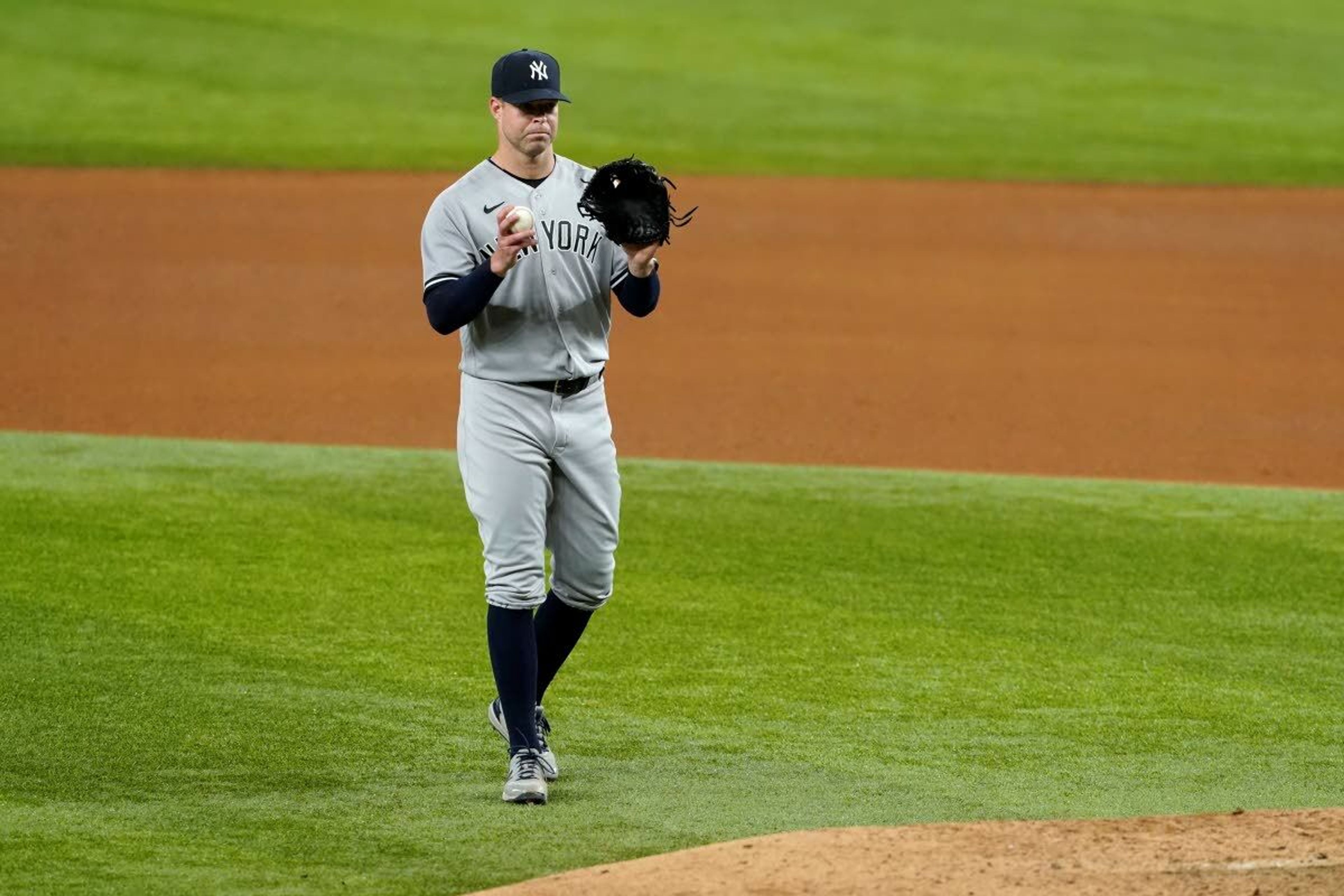 New York Yankees starting pitcher Corey Kluber calls for a fresh ball before throwing to Texas Rangers' Isiah Kiner-Falefa in the eighth inning of a baseball game in Arlington, Texas, Wednesday, May 19, 2021. (AP Photo/Tony Gutierrez)