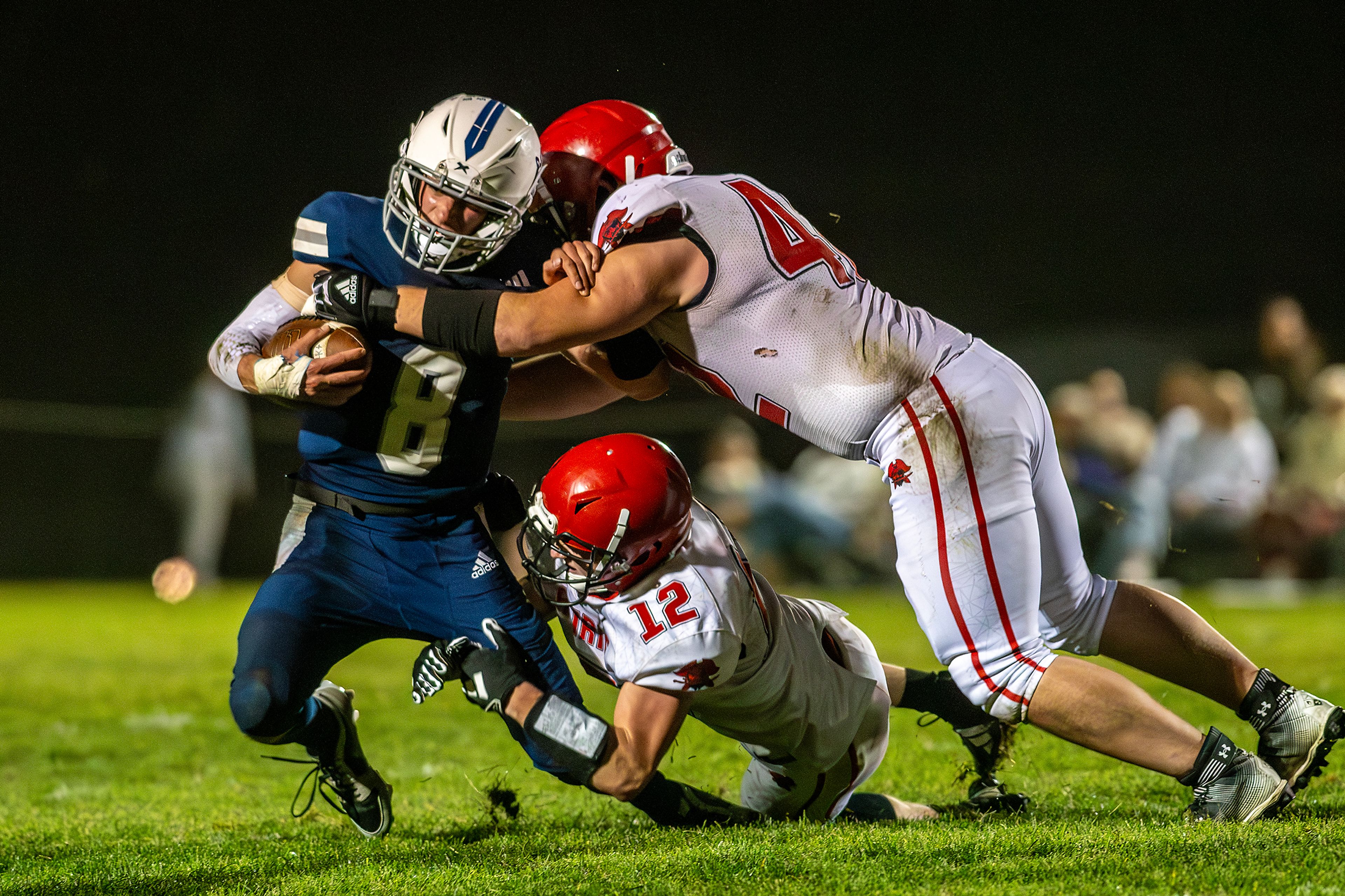 Logos Seamus Wilson is tackled by Prairie Matt Wemhoff (12) and another Prairie player during a conference game Friday in Moscow.,