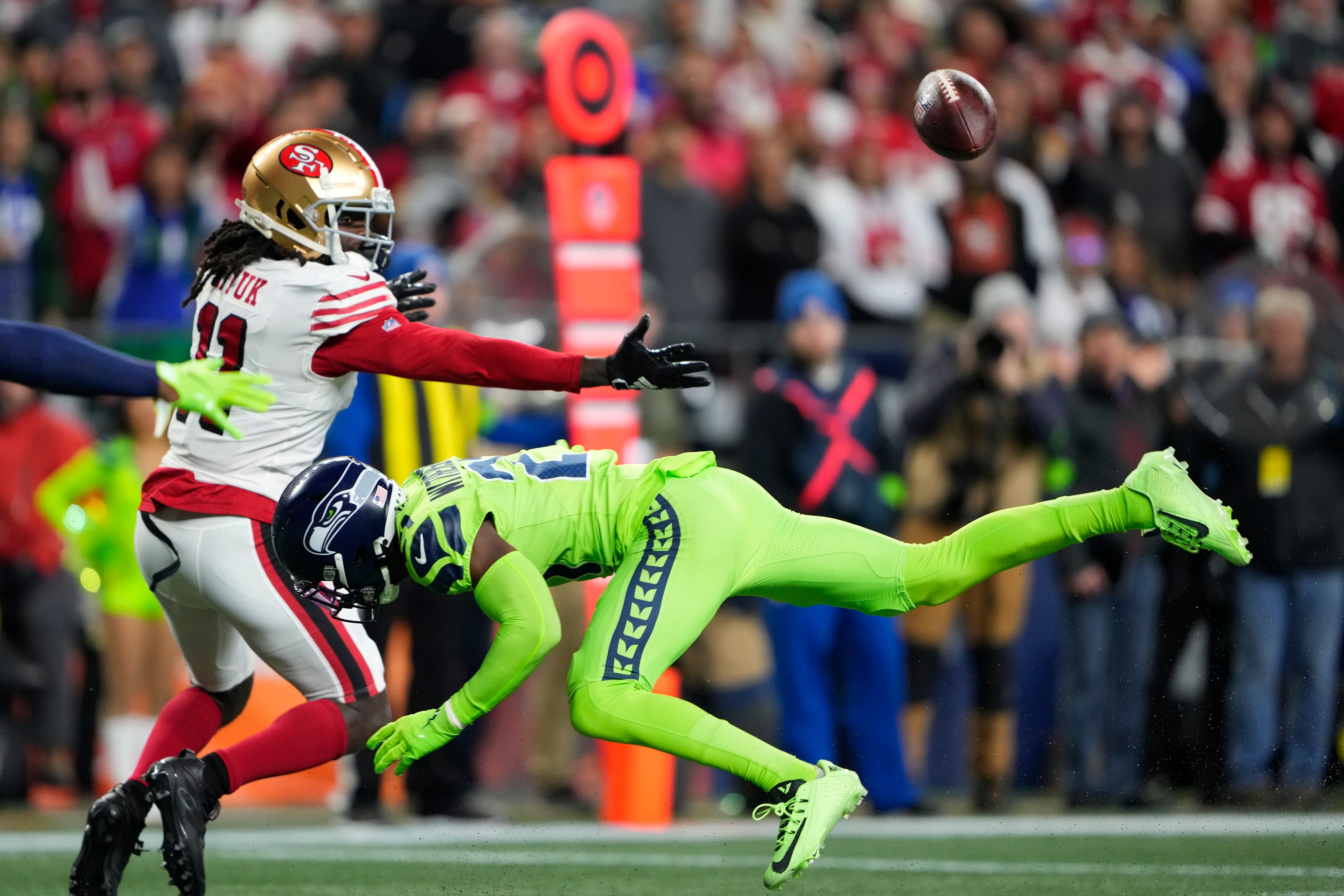 Seahawks cornerback Devon Witherspoon (21) breaks up a pass intended for 49ers wide receiver Brandon Aiyuk (11) during the first half of a game Nov. 23 in Seattle.