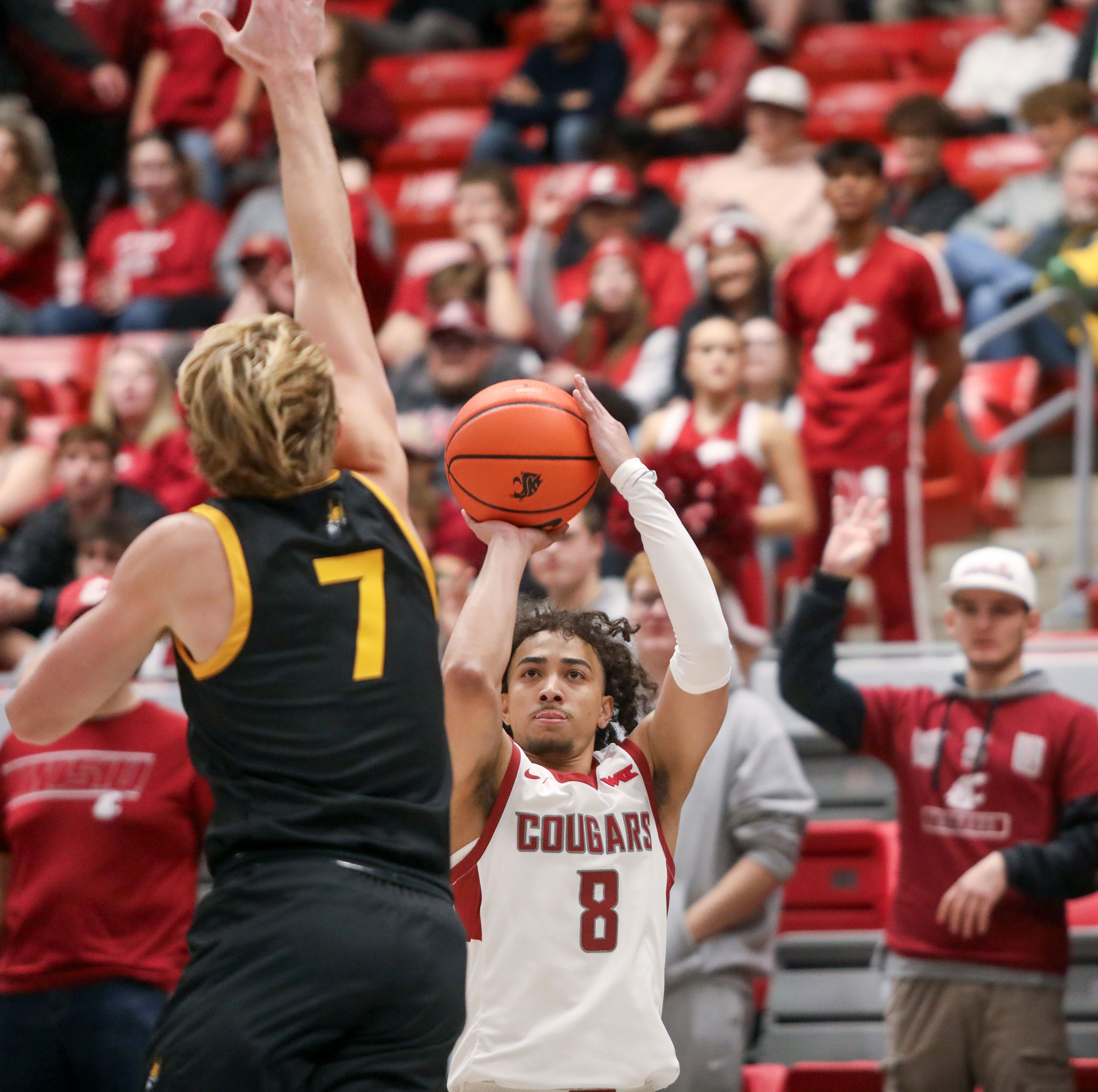 Washington State guard Nate Calmese prepares to make a three-point shot with pressure from Idaho guard Jack Payne Monday during the Battle of the Palouse game at Beasley Coliseum in Pullman.