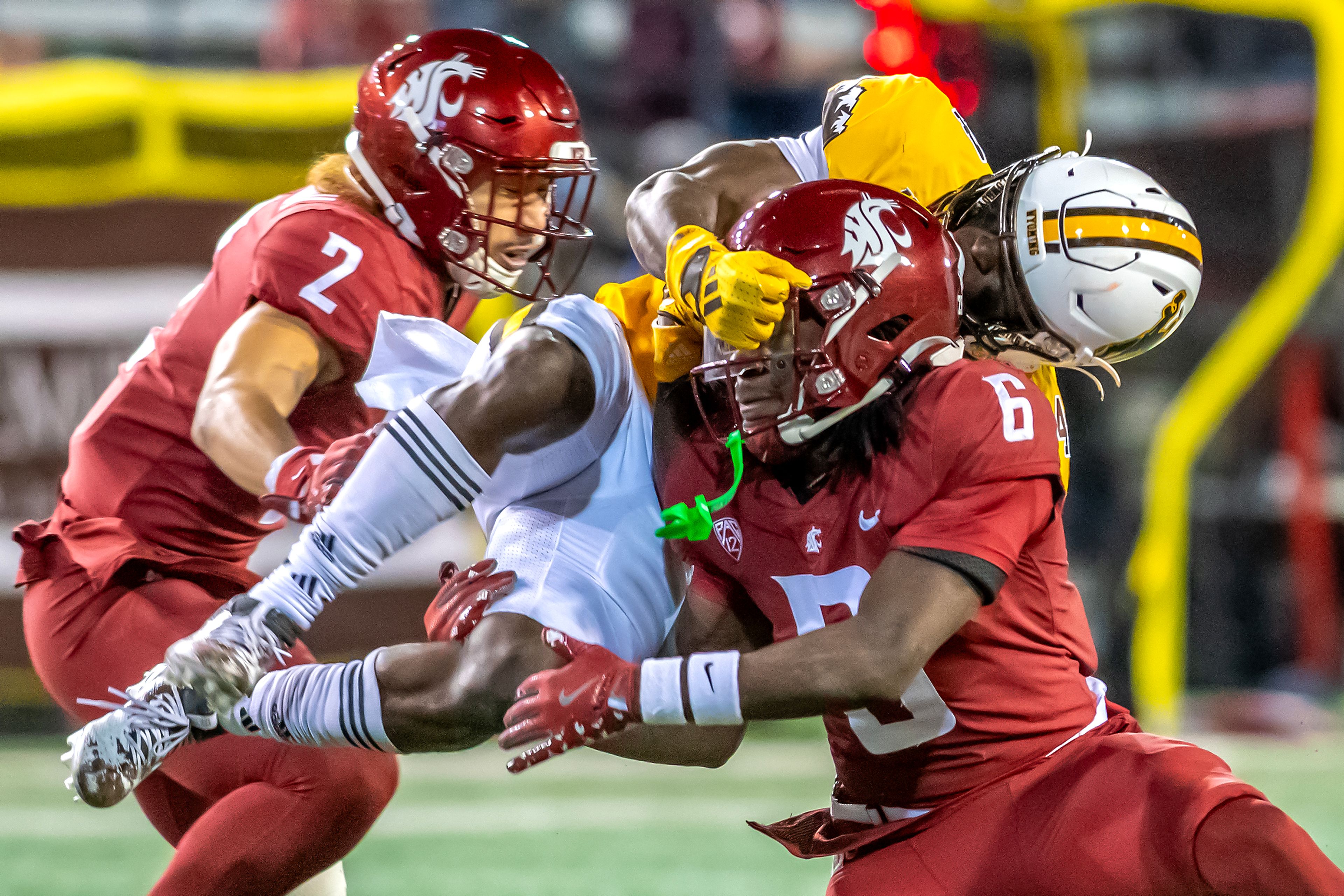 Washington State defensive back Adrian Wilson lifts up Wyoming running back Harrison Waylee on a tackle during a quarter of a college football game on Saturday, at Gesa Field in Pullman. Wyoming defeated Washington State 15-14.