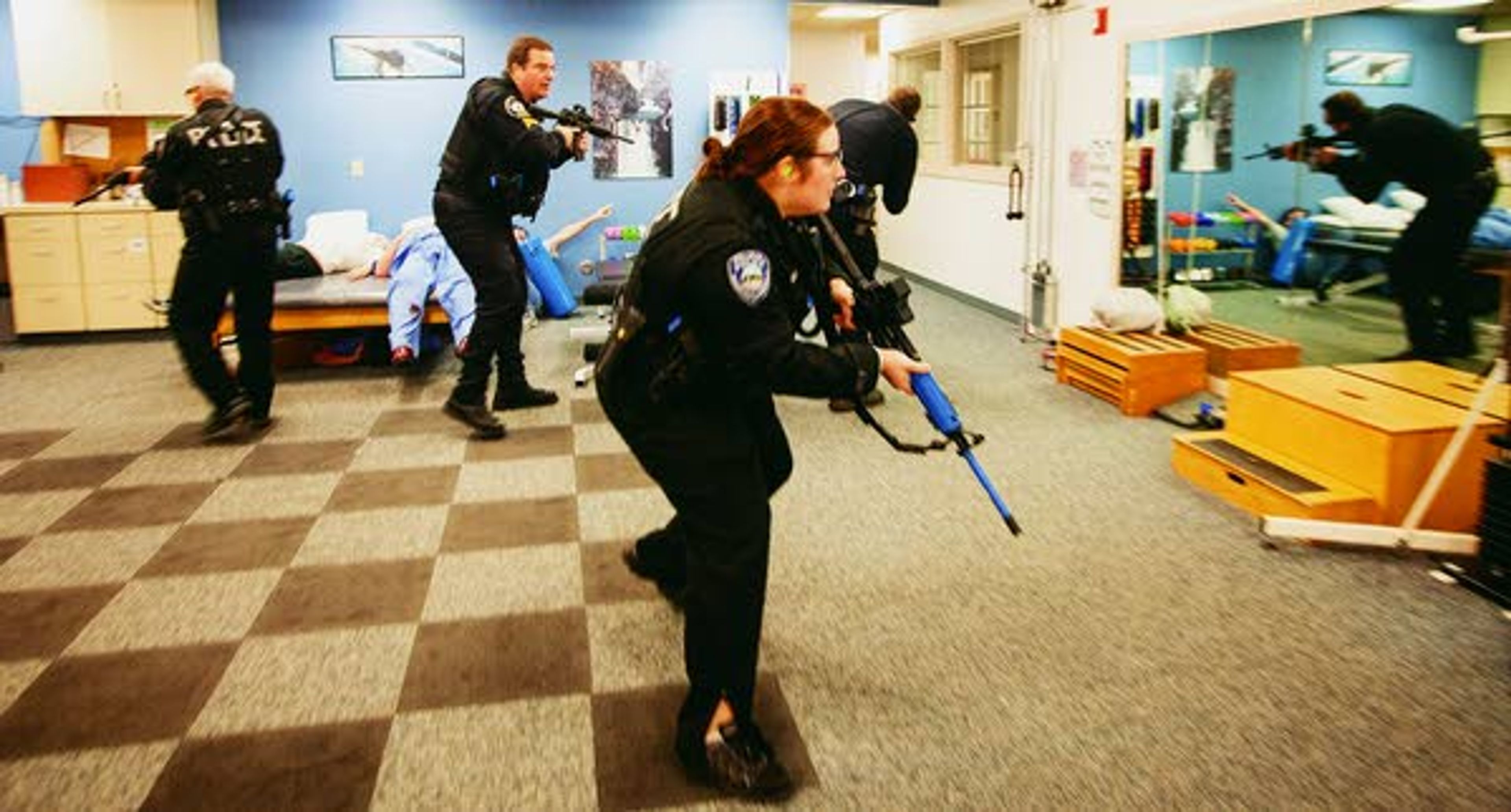 Police officers (left to right) Jeff Olmstead, Monty Griffin, Heidi Lambly and Chris Engle fan out as they search for 'the shooter' during an active shooter response drill run by the Pullman Police Department on Sunday at Summit Therapy in Pullman. Griffin and Olmstead are officers with the Washington State University Police Department.