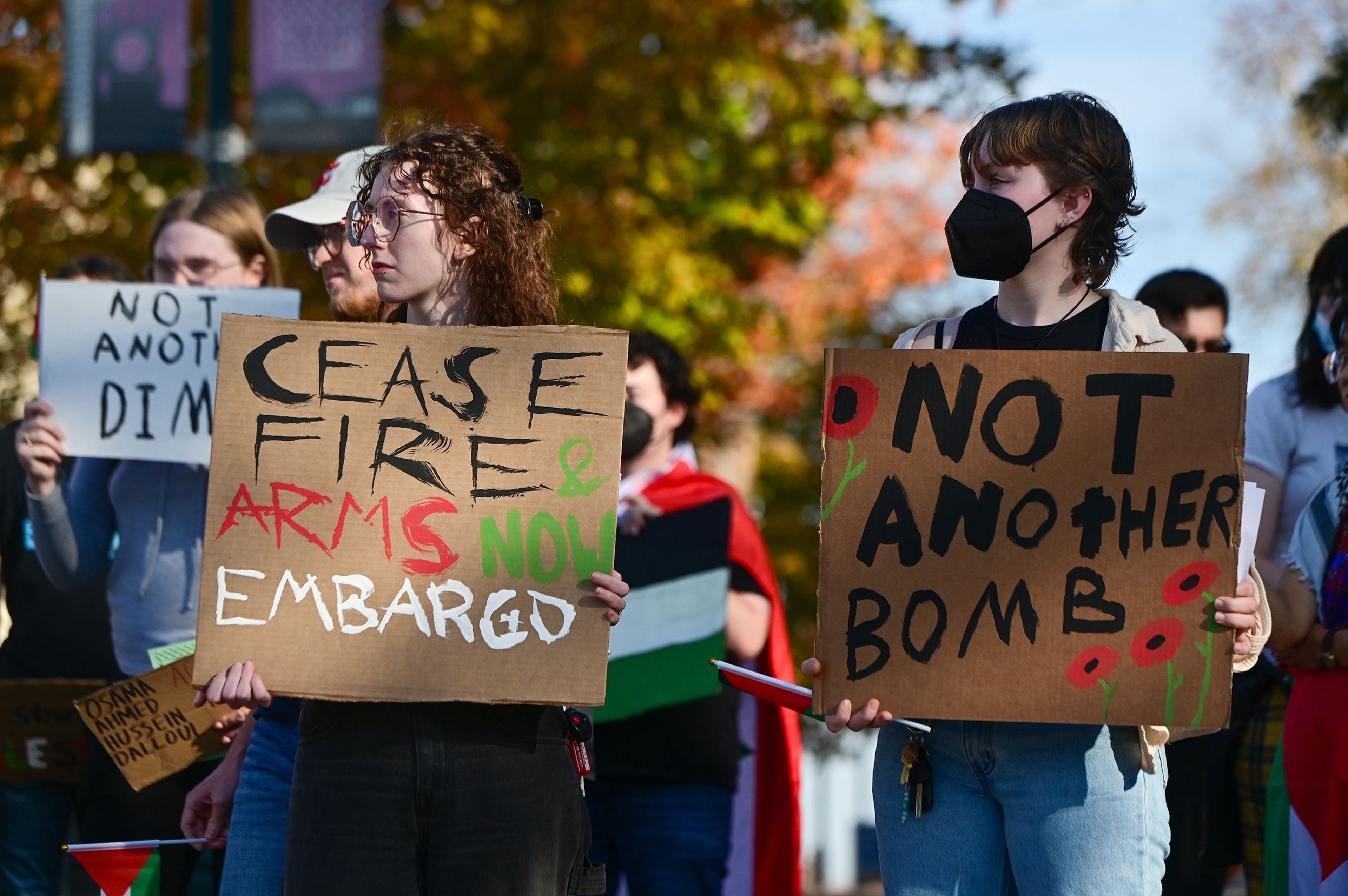 Andi Boyd, left, and Jaz Wright hold signs as they listen to speakers at a rally in solidarity for Palestine Monday on Washington State University campus in Pullman.