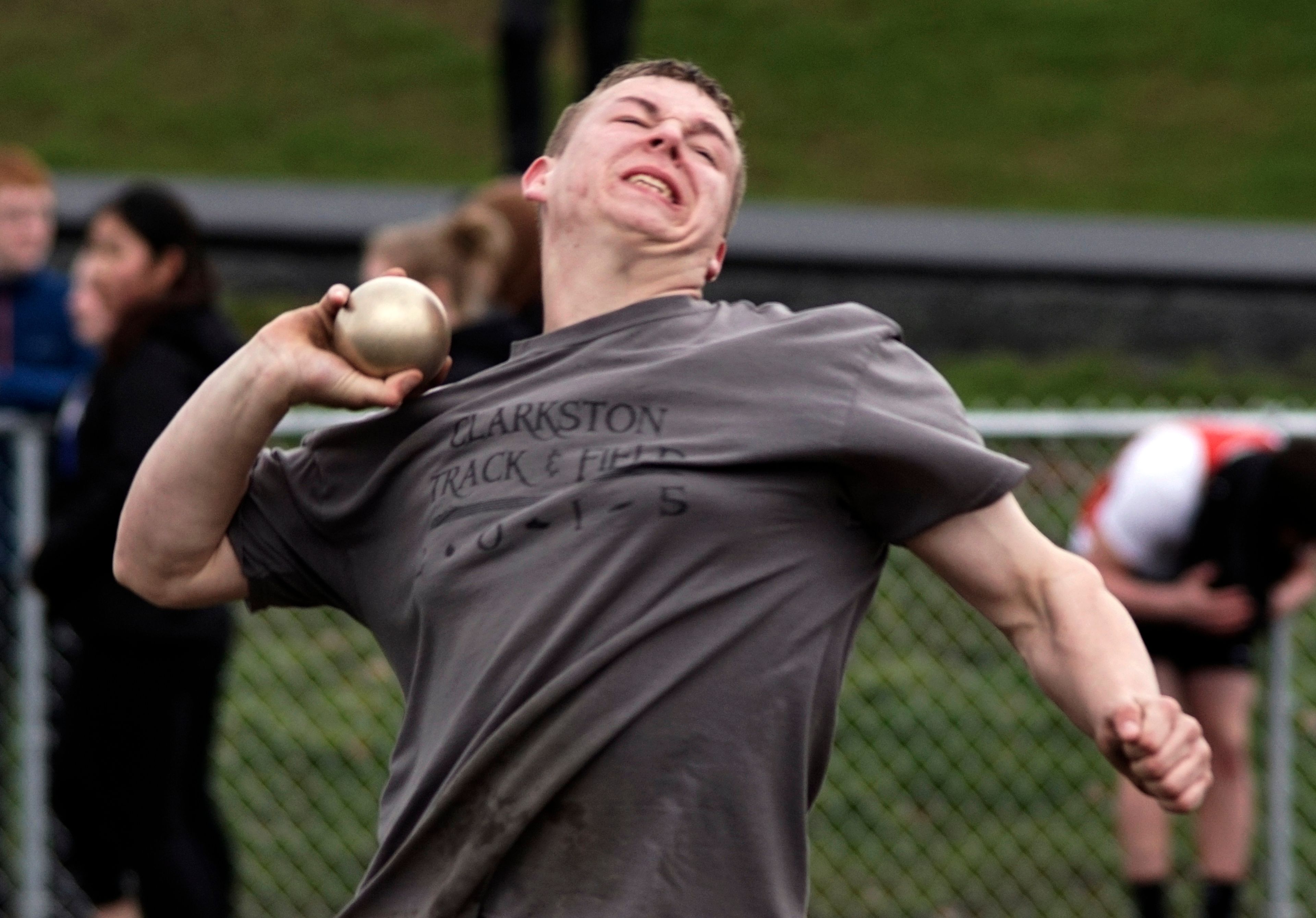 Clarkston's Dalton Phillips, who won the event, grimaces as he makes a throw in the shot put during a dual meet at Pullman on Wednesday.