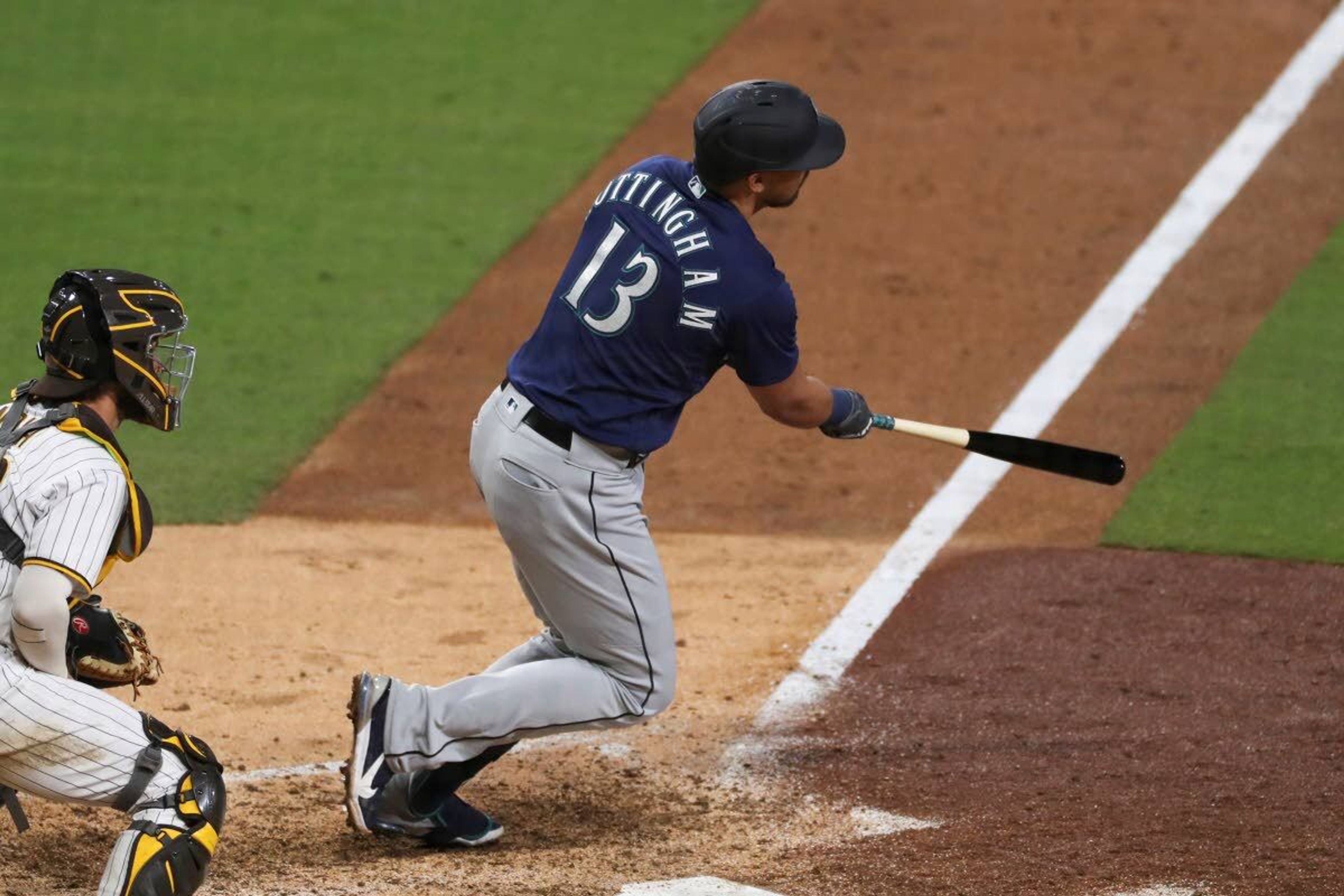 Seattle Mariners' Jacob Nottingham watches his sacrifice fly to right off San Diego Padres' Dinelson Lamet during the eighth inning of a baseball game Saturday, May 22, 2021, in San Diego. (AP Photo/Derrick Tuskan)