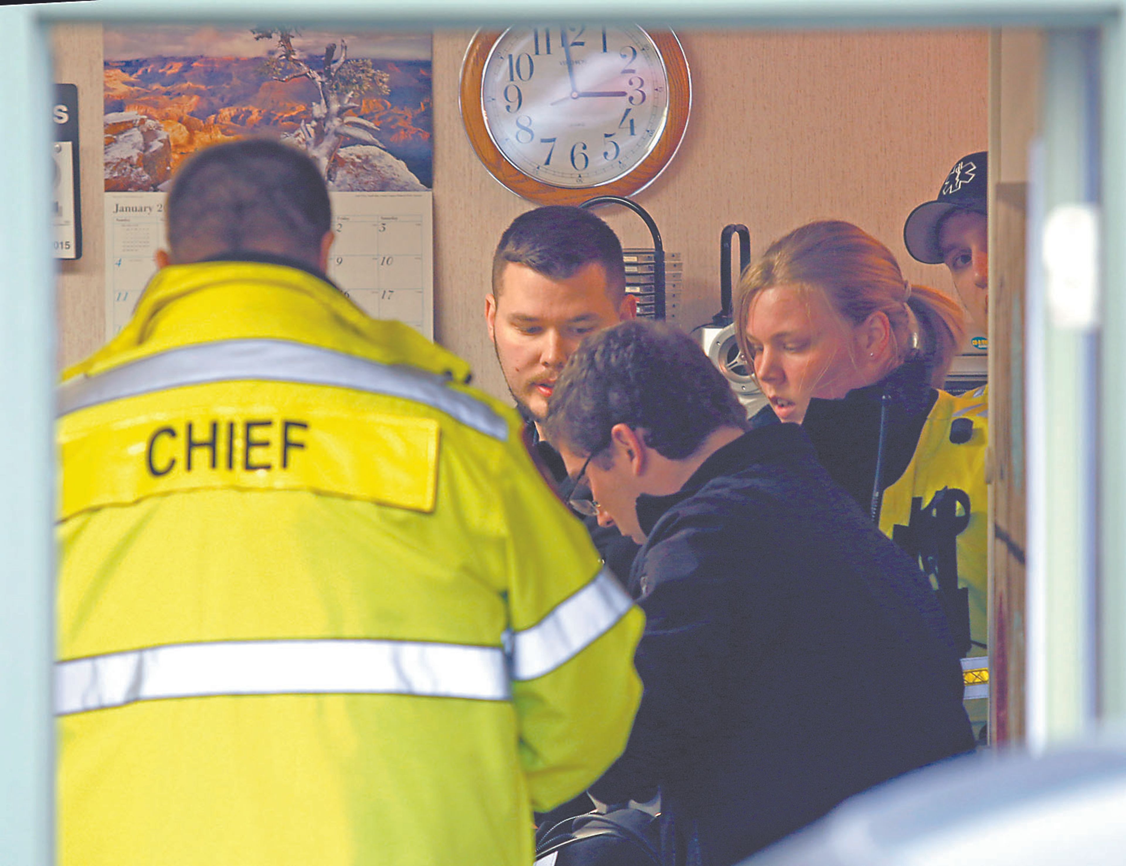 Emergency medical technicians from the Moscow Volunteer Fire Department aid one of two gunshot victims inside an office at the intersection of Jefferson and Third Streets in Moscow on Saturday. Two people were shot at the office, and a third was shot at Arby's in Moscow.