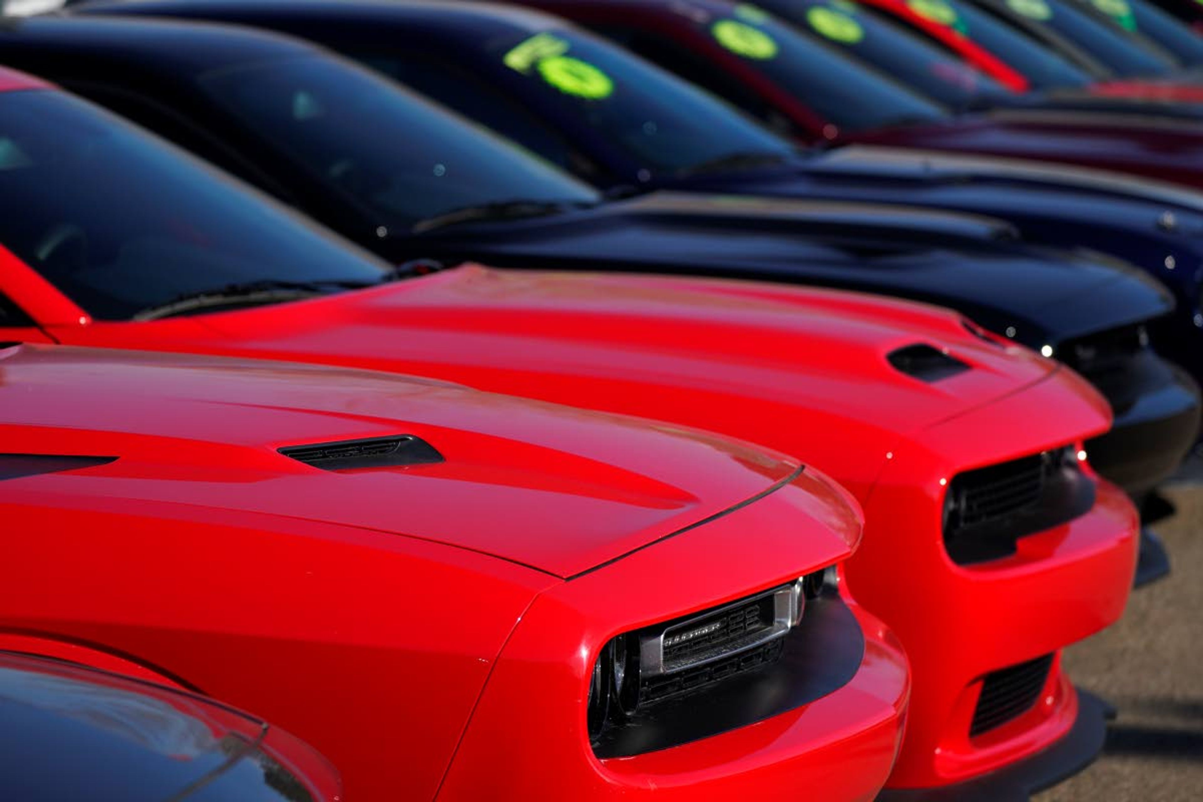 This Jan. 24 photo shows a long line of used Challengers at a Dodge dealership in Littleton, Colo.