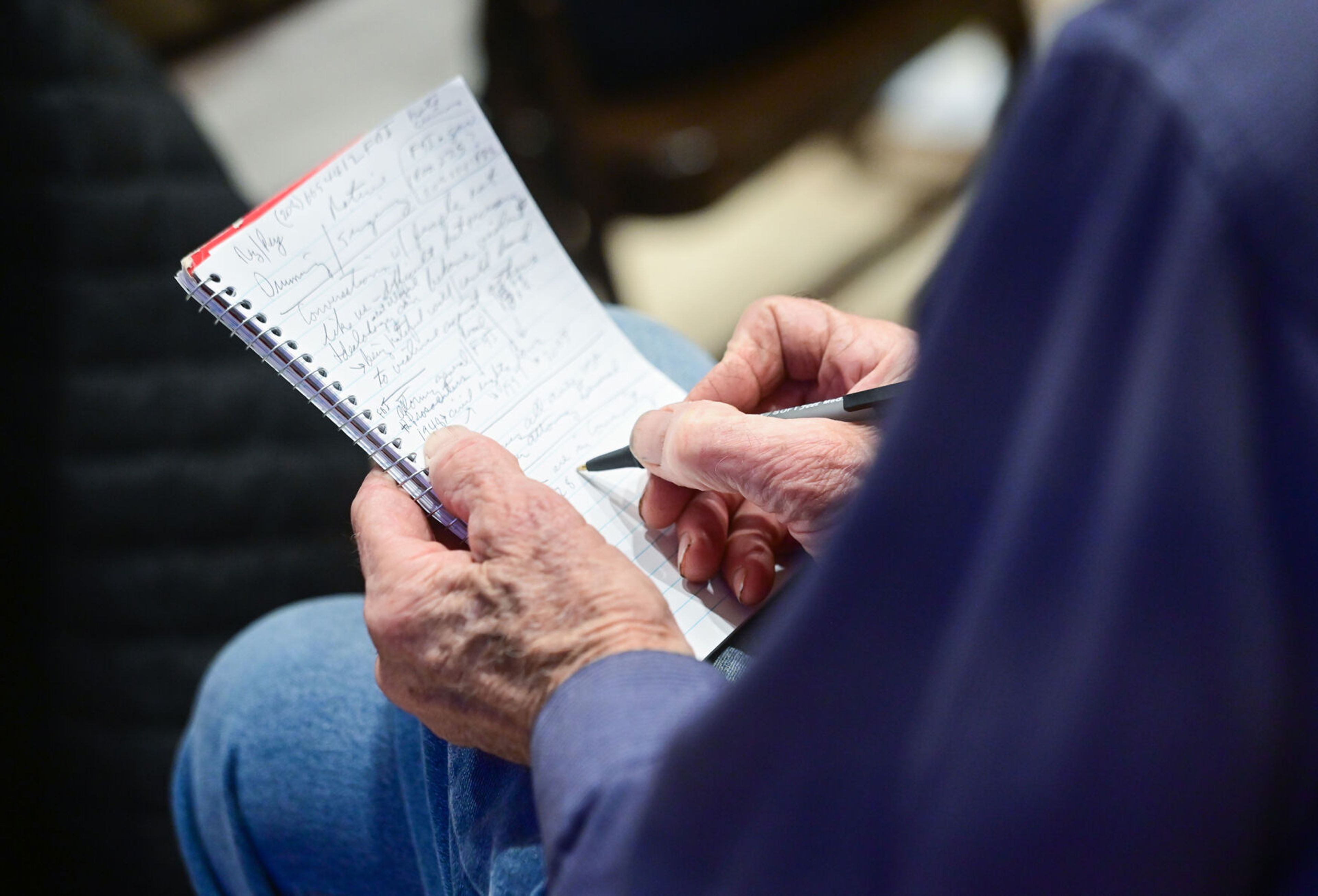 Attendees of a United Against Hate summit Monday take notes as federal and local representatives speak at the 1912 Center in Moscow.