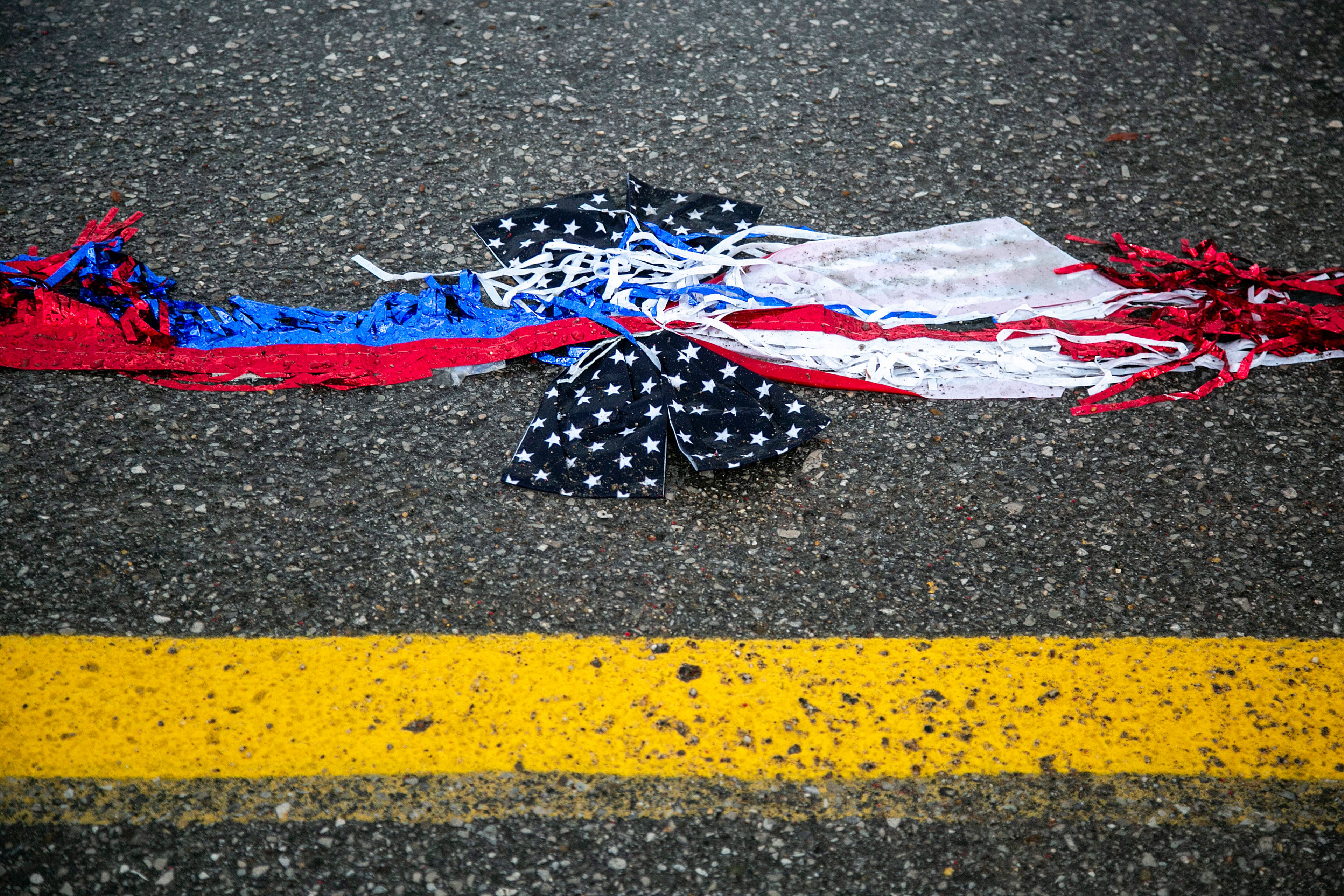 A piece of a parade float is seen in a puddle as rain pours down after the 4thFest parade was canceled due to severe weather on Independence Day, Monday, July 4, 2022, in Coralville, Iowa. (Joseph Cress/Iowa City Press-Citizen via AP)