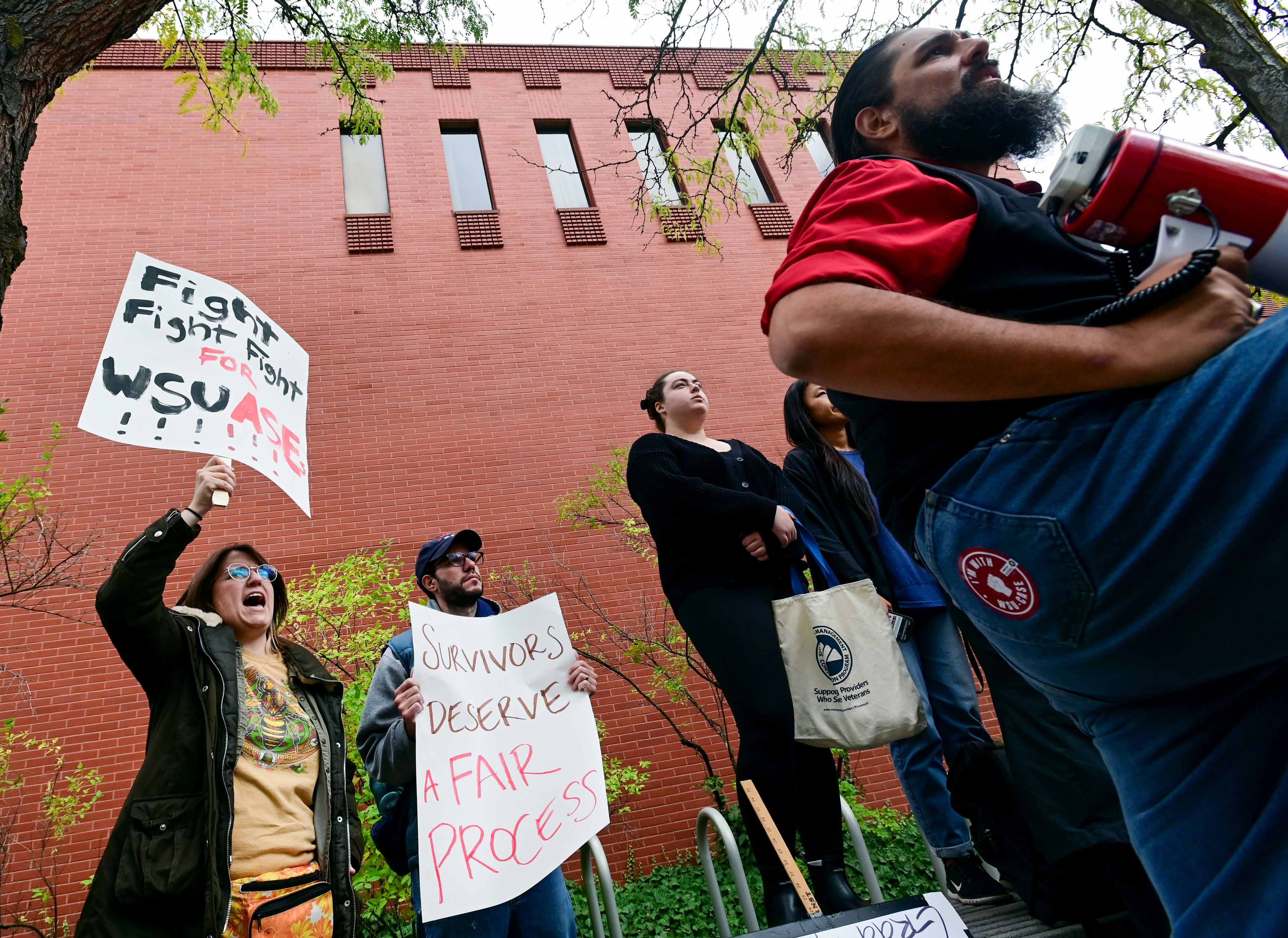 Sam Dilday, left, a second-year PhD student in entomology at Washington State University, cheers in response to a speaker at a rally supporting contract negotiations for Academic Student Employees in front of the French Administration Building on Wednesday in Pullman. Dilday also spoke at the rally before the group marched down Glenn Terrell Mall.