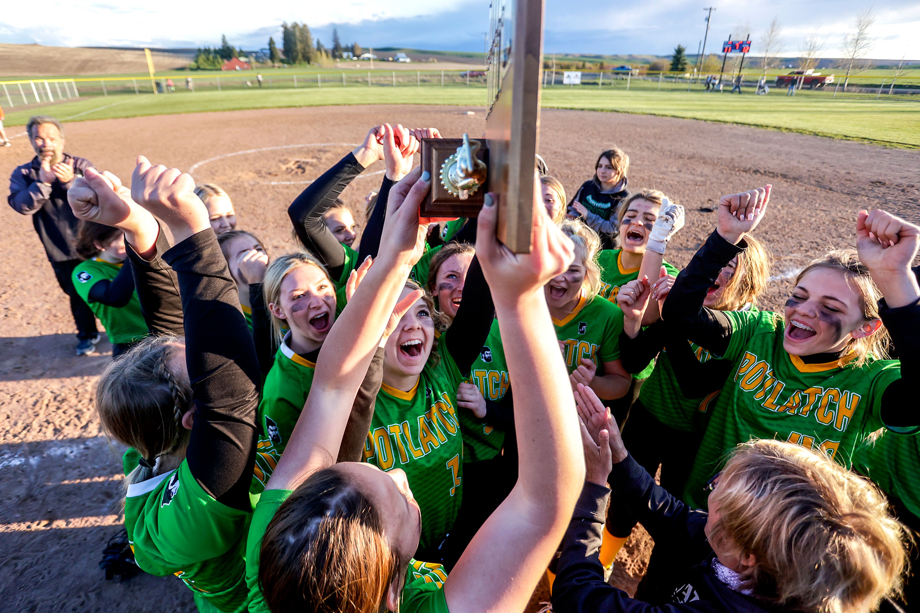 Potlatch players raise their trophy high in the air as they celebrate their 12-11 victory over Kendrick in the Class 1A district final Wednesday in Genesee