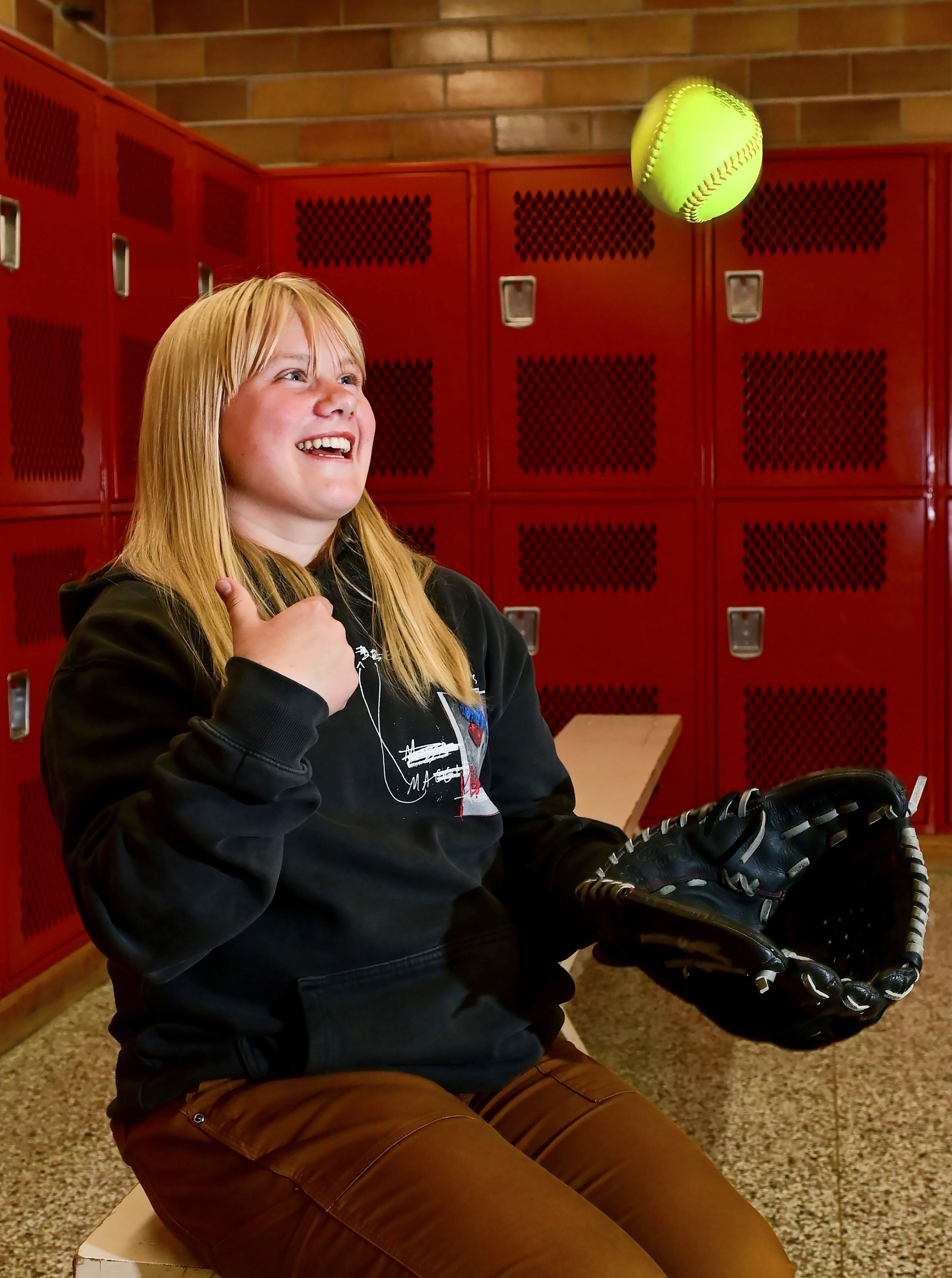 Graduating Moscow High School senior Addison Branen catches a softball in the school’s locker room on Tuesday. Branen is a 4.0 student who is signed to play college softball.