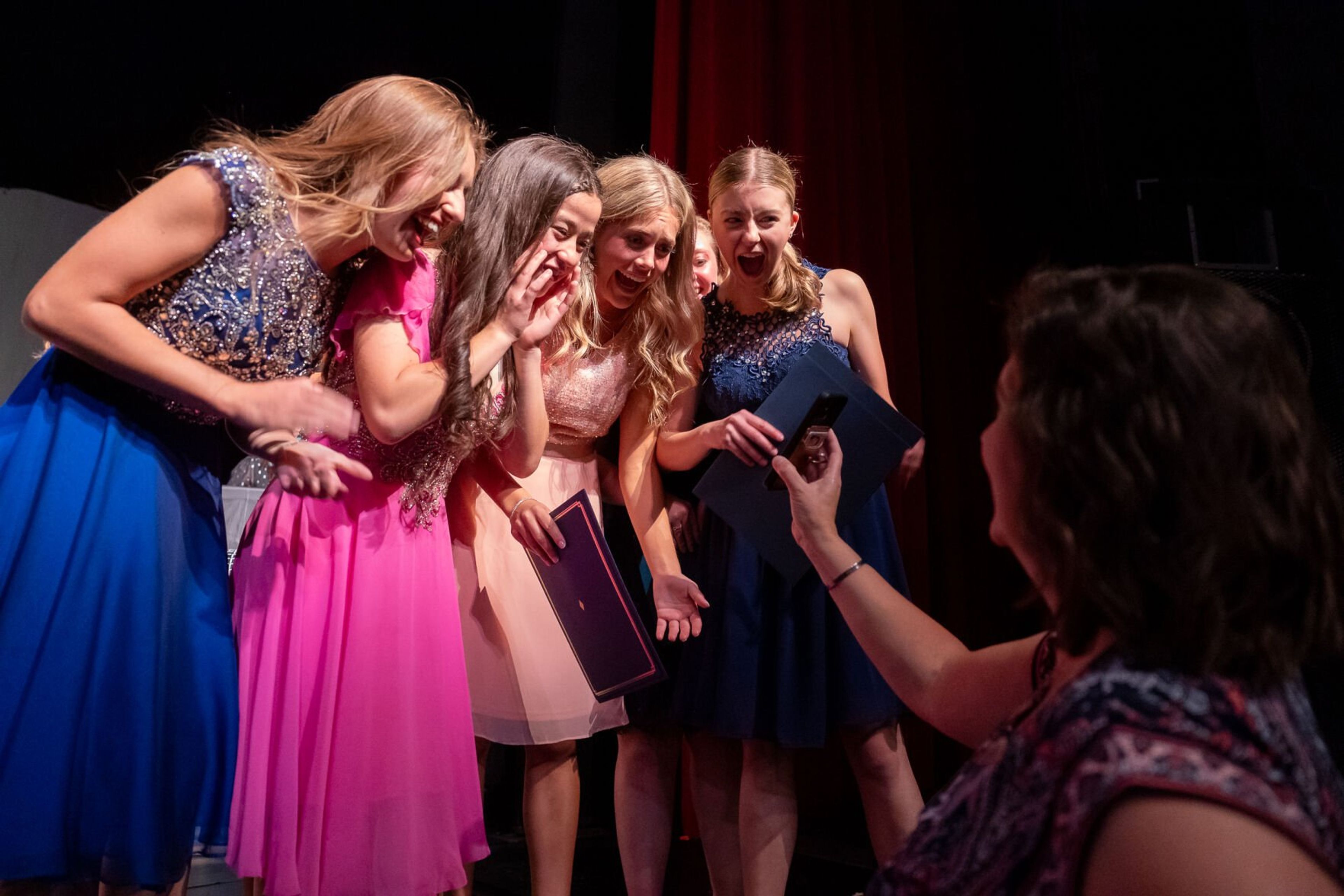 Beth Okamoto, from left, Gracie Wessels and Audrey Maryott react after Sydney Ohlemann is announced as the winner of the Washington Distinguished Young Woman competition on Saturday at Daggy Hall in Pullman. Ohlemann was unable to attend the event in person, but participated in each category of the competition through a Zoom call earlier in the day.