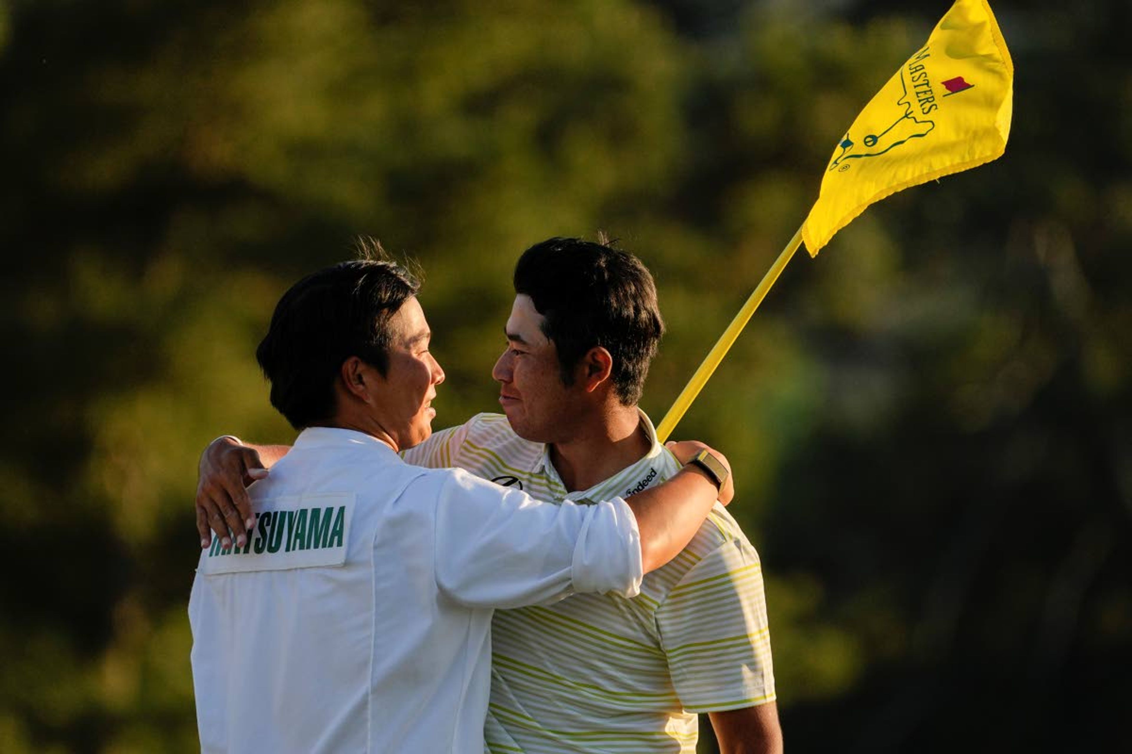 Hideki Matsuyama, of Japan, hugs his caddie Shota Hayafuji after winning the Masters golf tournament on Sunday, April 11, 2021, in Augusta, Ga. (AP Photo/David J. Phillip)