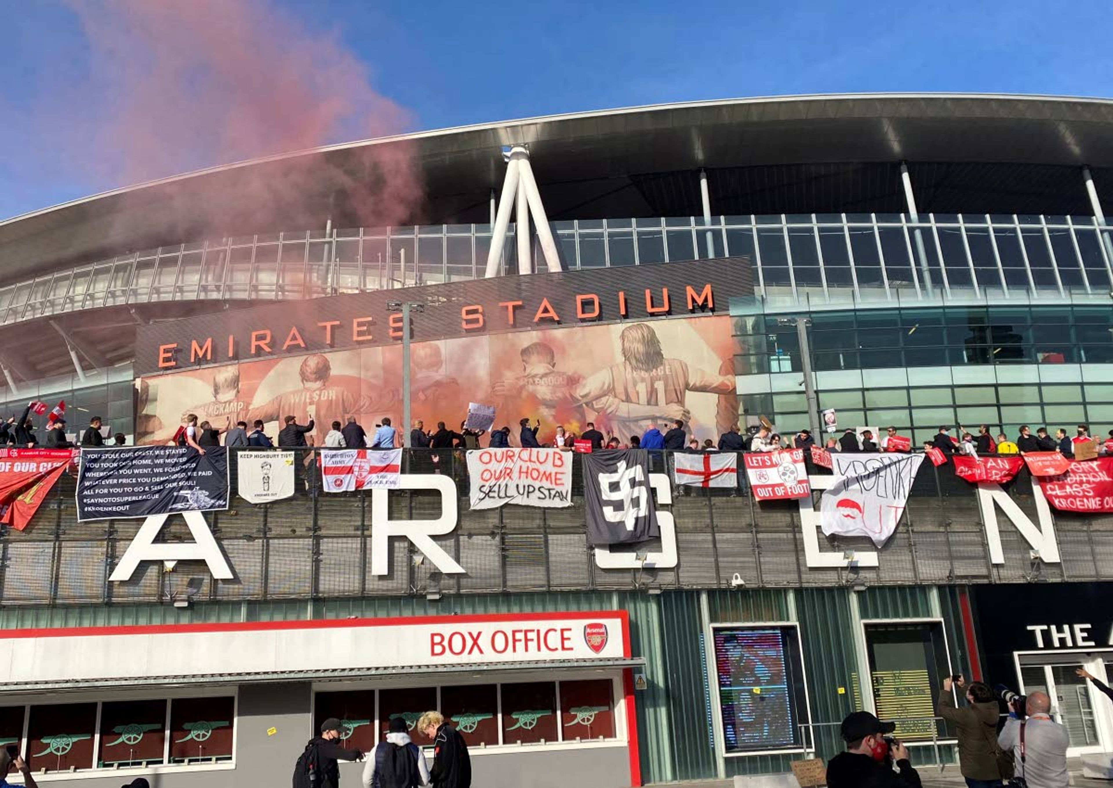 FILE - In this Friday April 23, 2021 file photo, fans protest against Arsenal owner Stan Kroenke before their English Premier League soccer match against Everton, outside the Emirates Stadium in London. The fans want owner Stan Kroenke to leave the club over its bid to join the failed Super League. Only nine of the 12 European clubs who launched an ill-fated bid to form a Super League have agreed to a peace deal with UEFA and accepted being fined millions of dollars, Friday May 7, 2021. The remaining trio of rebels, Barcelona, Real Madrid and Juventus, are at risk of being banned from the Champions League for not renouncing the breakaway. (AP Photo/Frank Griffiths, File)