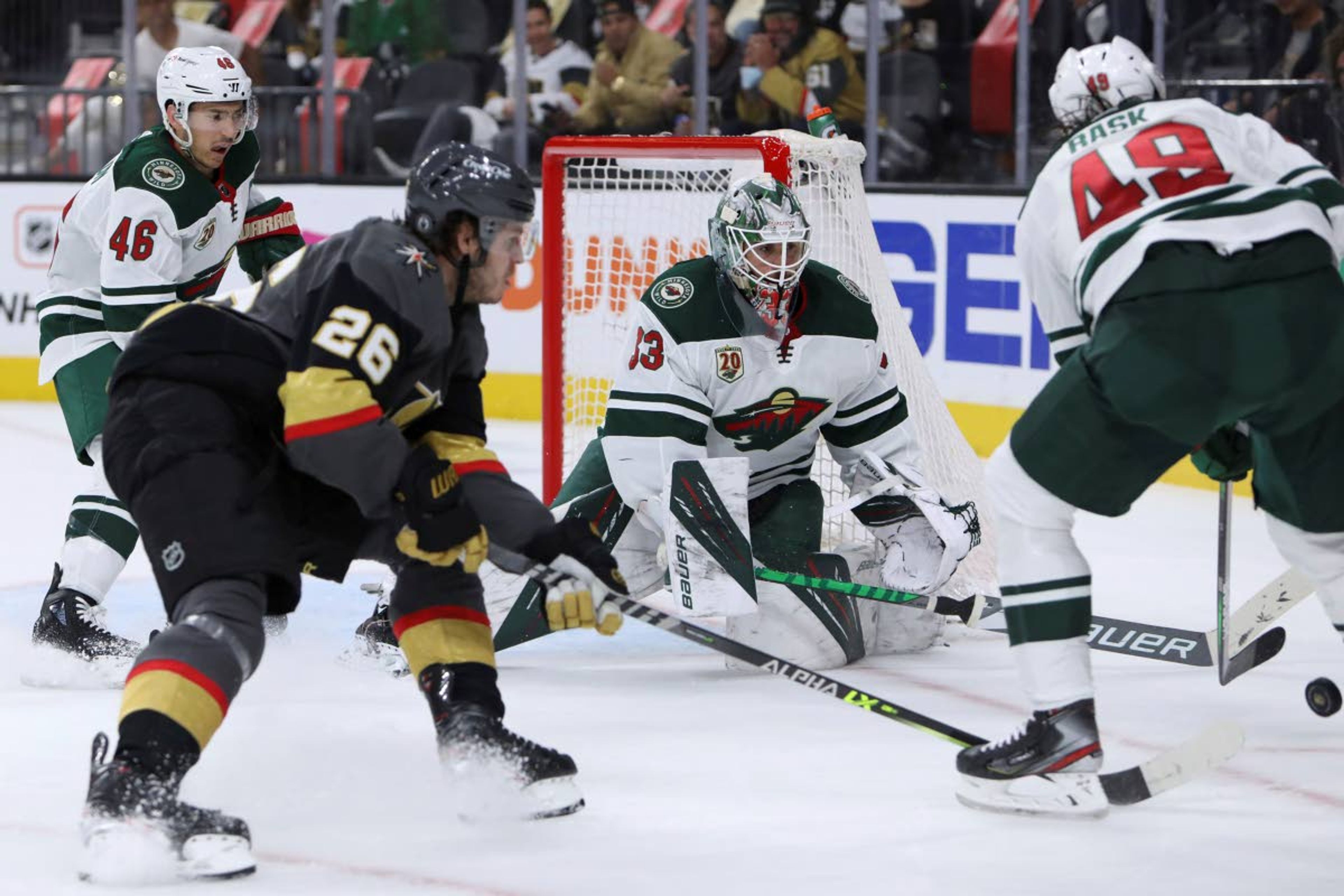 Associated PressWild goalie Cam Talbot (33) tries to keep the puck away from Golden Knights center Mattias Janmark (26) during the second period of Game 7 of an NHL Stanley Cup first-round playoff series Friday in Las Vegas.