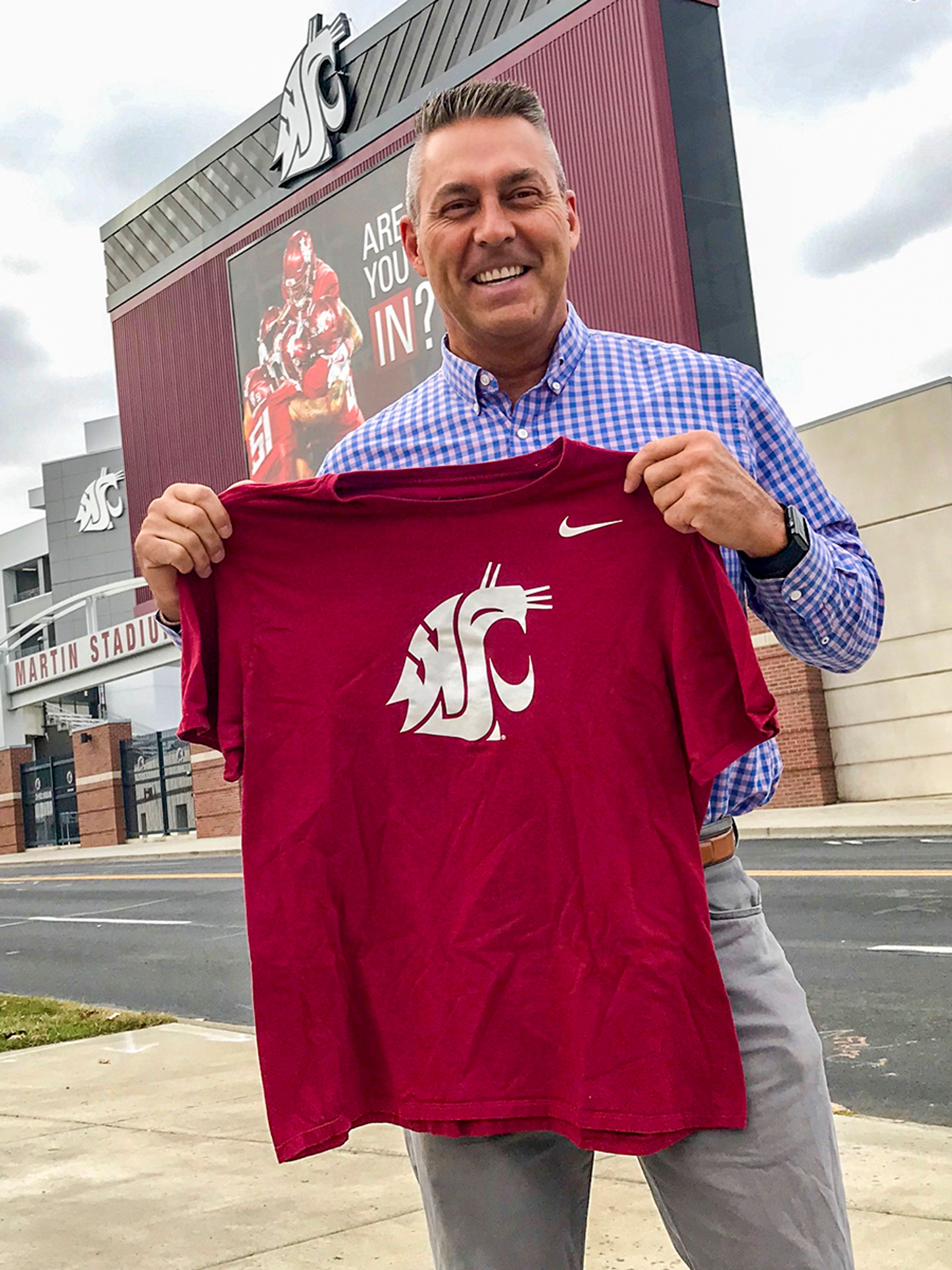 Gary Rubens poses for a picture outside of Martin Stadium on Washington State University’s campus in Pullman. Rubens is one of more than 4,700 spring term graduates from the six WSU campuses across the state.