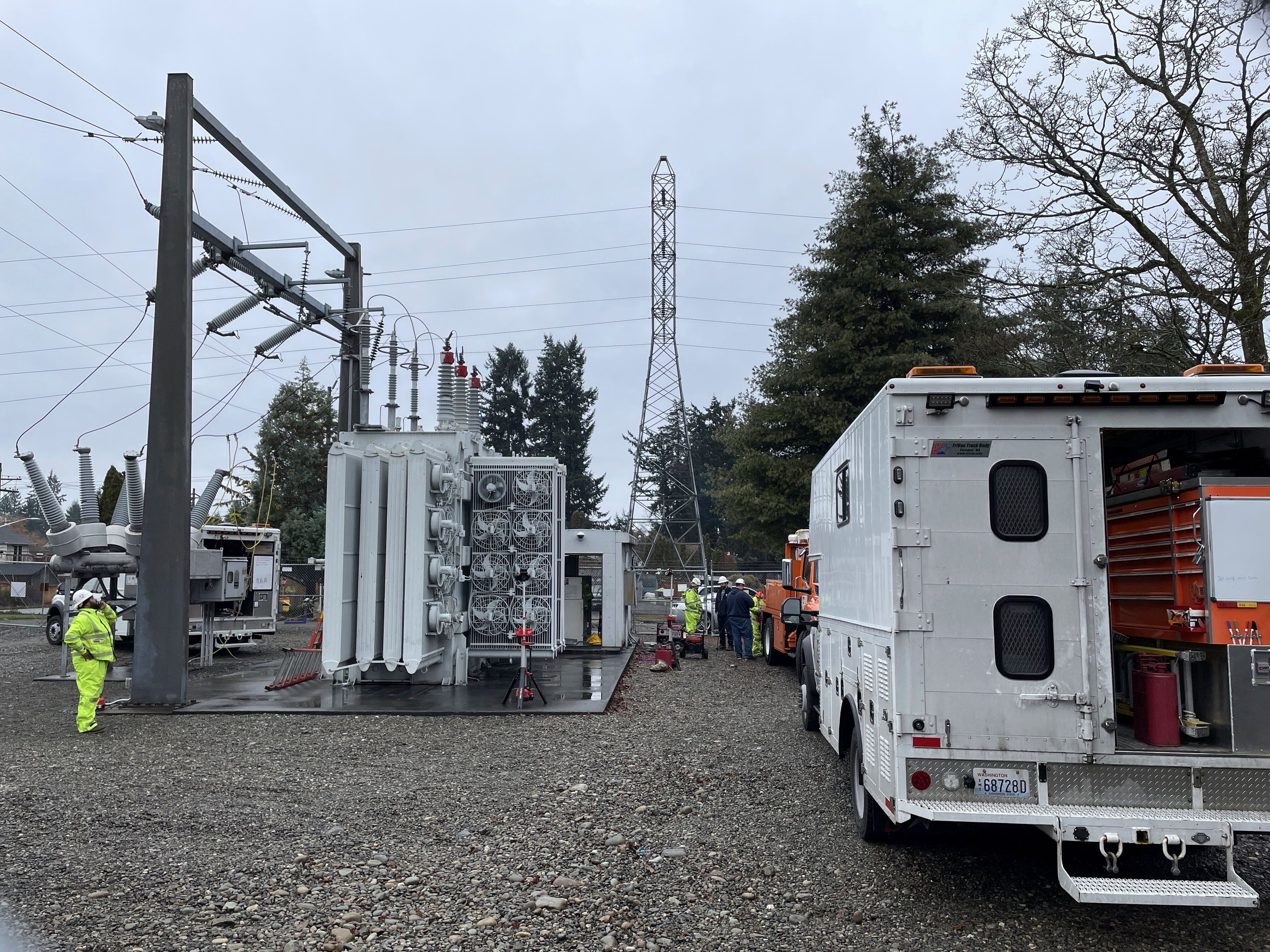 A Tacoma Power crew works at an electrical substation damaged by vandals early on Christmas morning after cutting a padlock to gain entry according to a crew manager, Sunday, Dec. 25, 2022 in Graham, Wa. (Ken Lambert/The Seattle Times via AP)