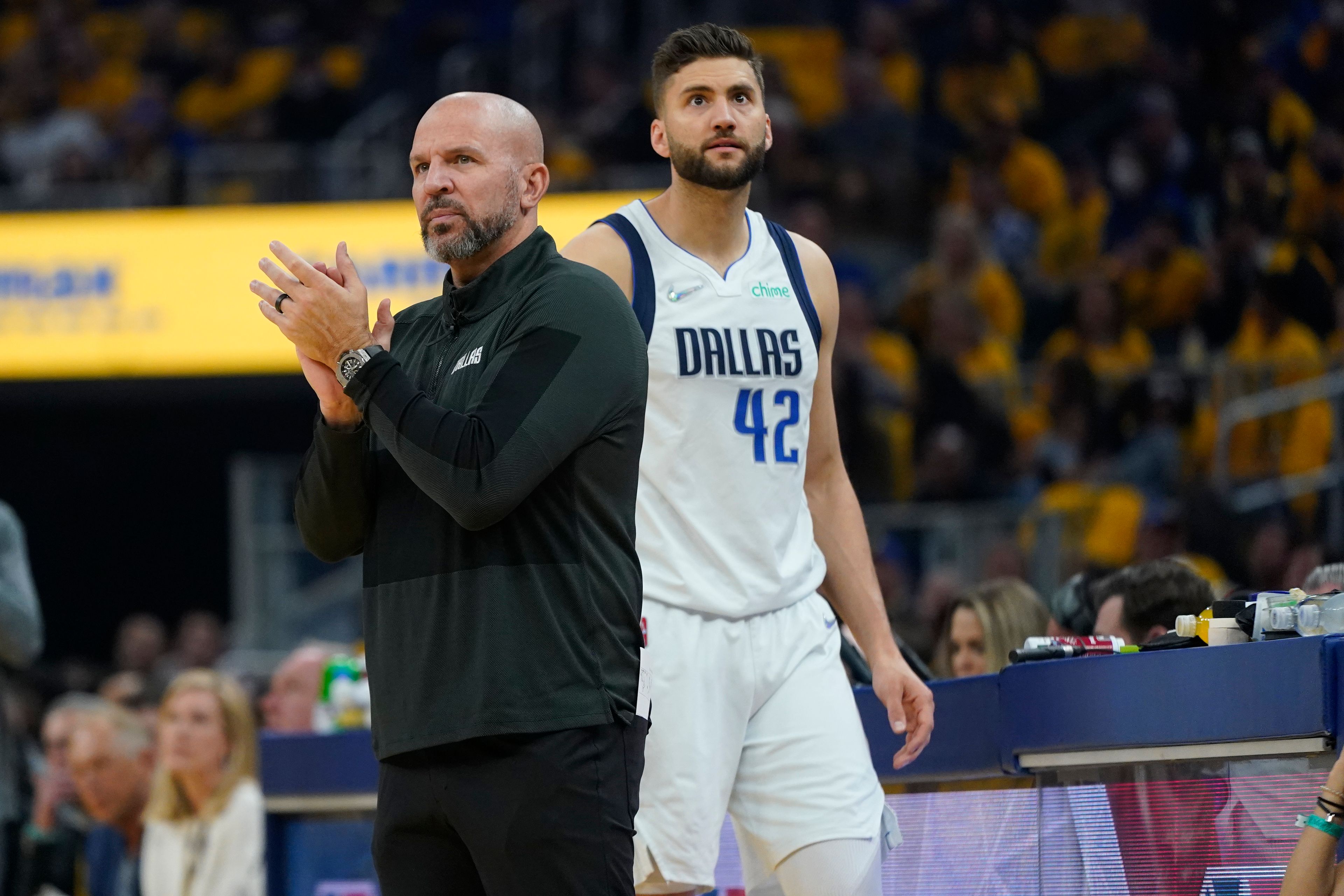 Dallas Mavericks coach Jason Kidd, left, claps next to forward Maxi Kleber (42) during the first half in Game 5 of the team's NBA basketball playoffs Western Conference finals against the Golden State Warriors in San Francisco, Thursday, May 26, 2022. (AP Photo/Jeff Chiu)