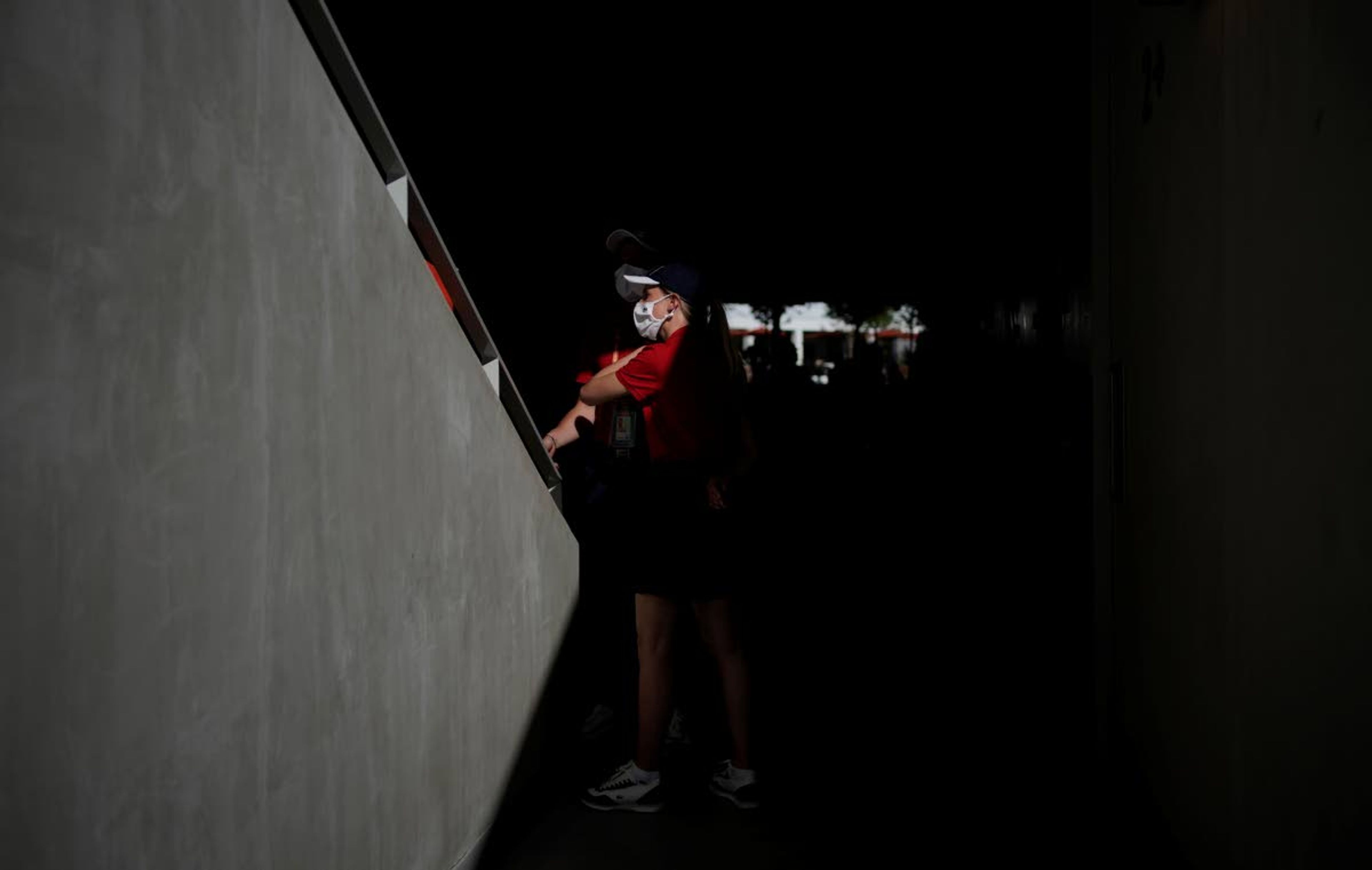 Court attendants on the Philippe Chatrier court wear face masks against the coronavirus wait to left spectators on to the court on day three of the French Open tennis tournament at Roland Garros in Paris, France, Tuesday, June 1, 2021. (AP Photo/Christophe Ena)