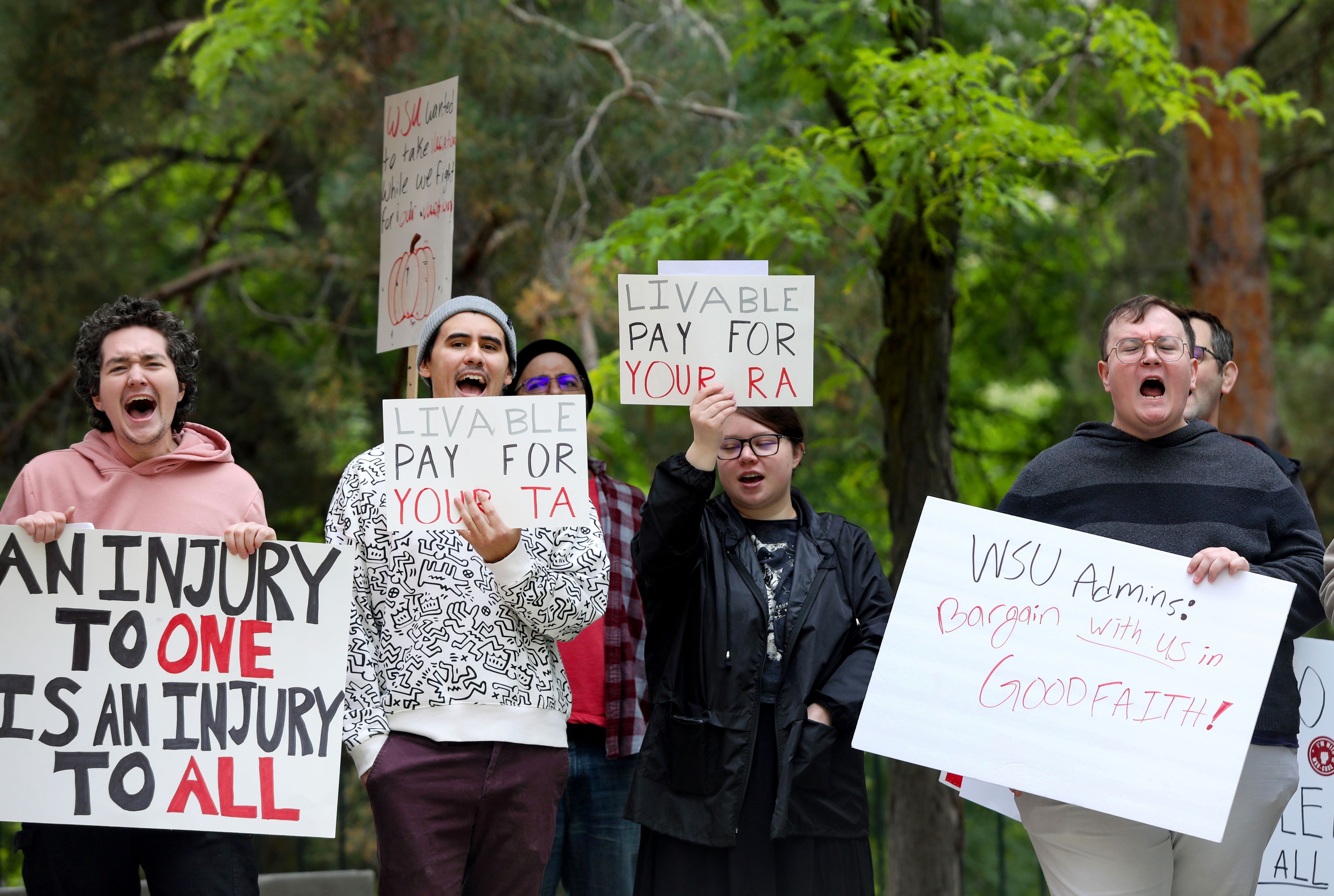 Students take part in call-and-response chants at a rally supporting contract negotiations for Academic Student Employees in front of the French Administration Building on Wednesday in Pullman. The group marched down Glenn Terrell Mall after listening to a series of speakers.