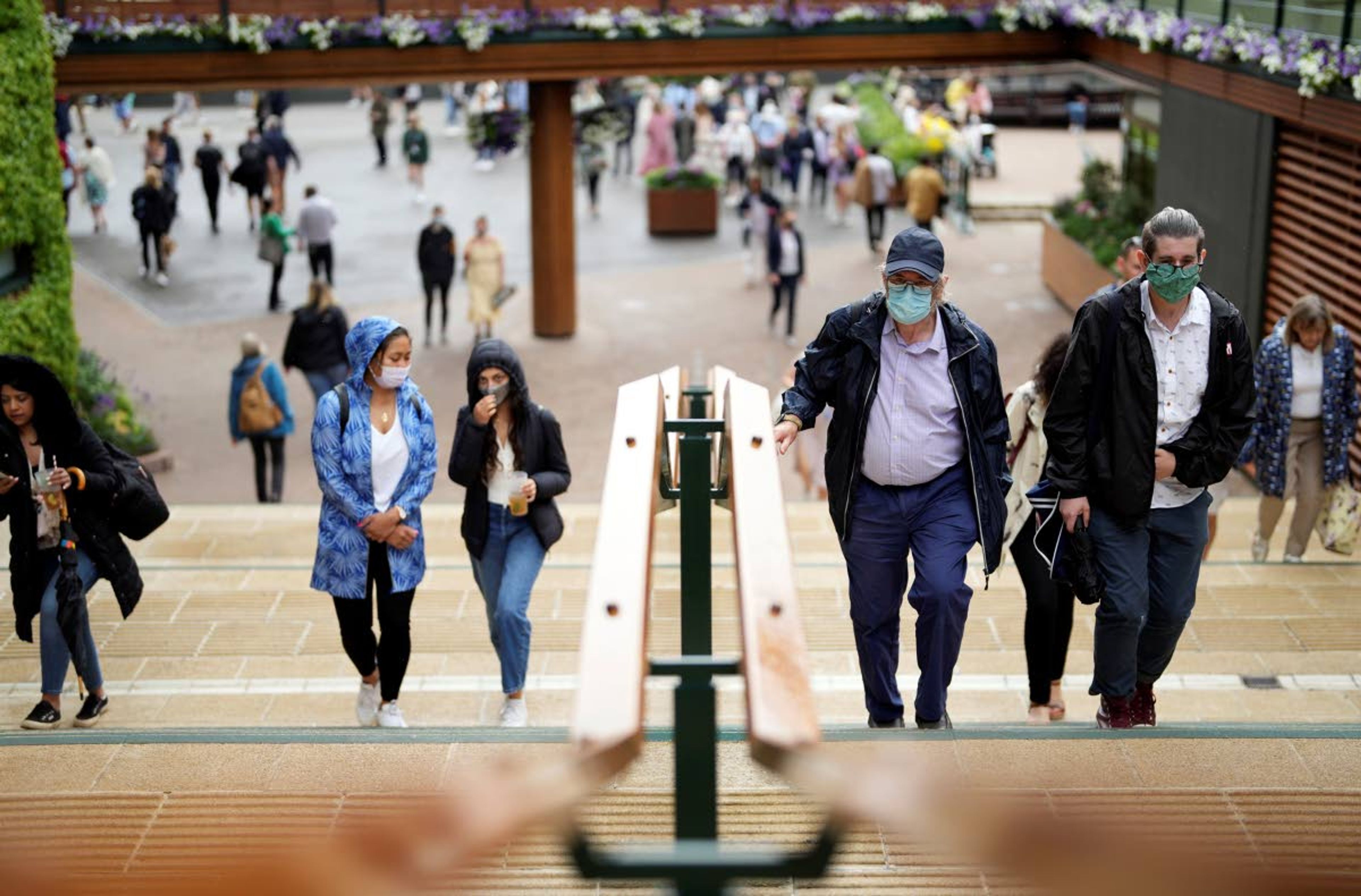 People walk around the grounds on day one of the Wimbledon Tennis Championships in London, Monday June 28, 2021. (AP Photo/Alberto Pezzali)