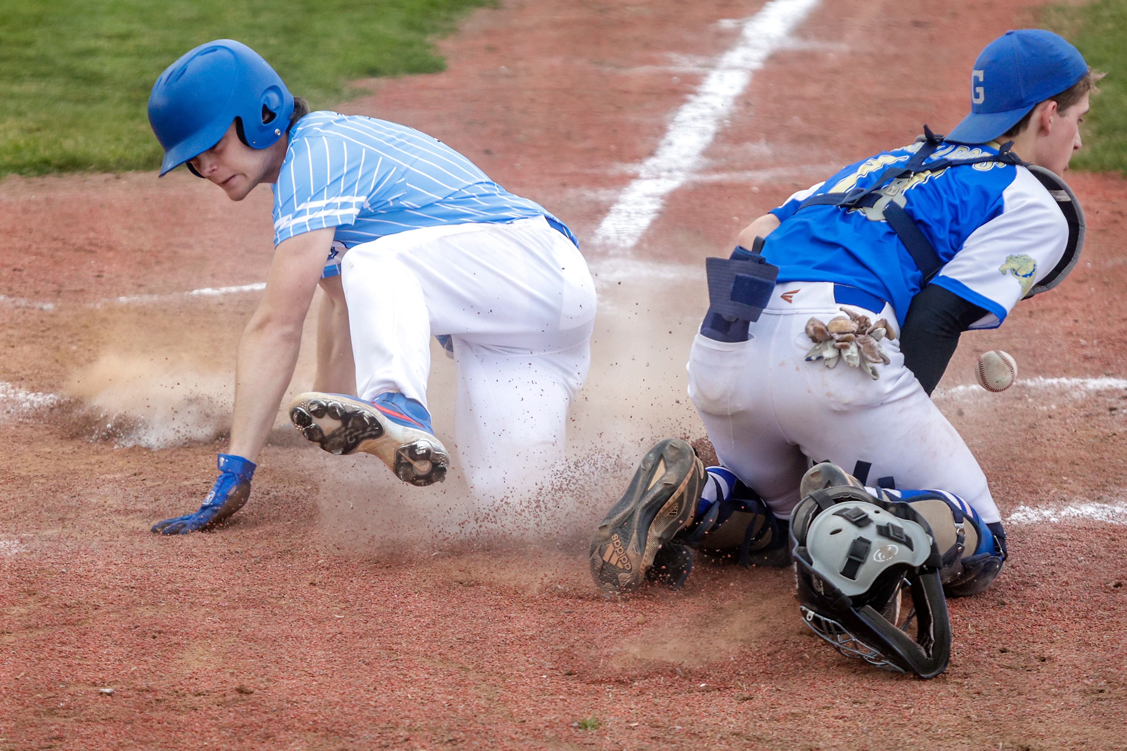 Colton Kane Weiker slides safely into home as the ball bounces off Genesee pitcher Nate Guinard in Genesee on Monday.