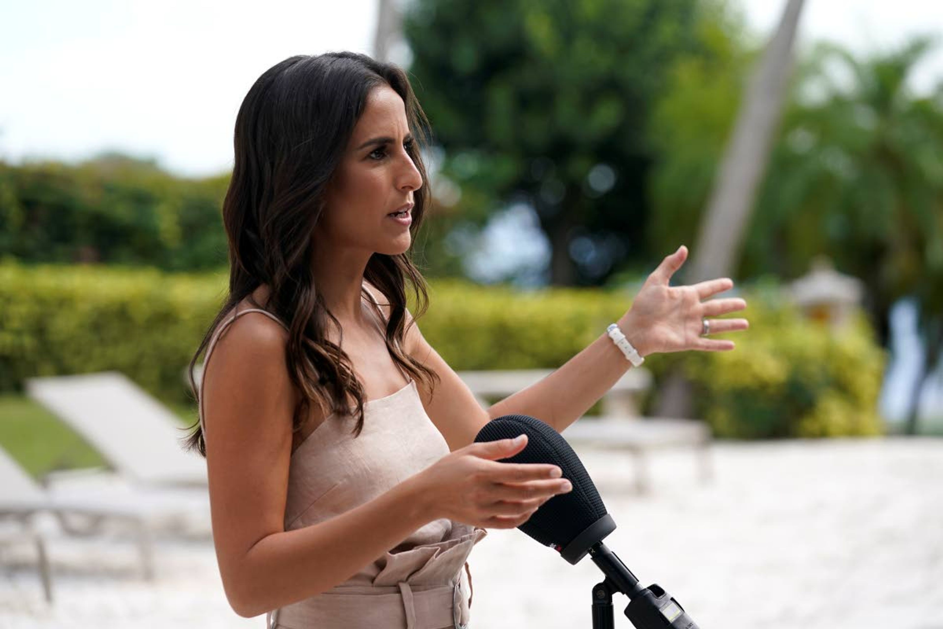 Realtor Ruthie Assouline is interviewed outside the house formally owned by pop star Madonna, Monday, Nov. 15, 2021, in Miami. Assouline nabbed the listing with her husband Ethan for the 51,000 square-foot home in a private enclave of six houses on the same street where Sly Stallone once lived. The estate, purchased 20 years ago from the pop star, was listed for sale Wednesday. (AP Photo/Lynne Sladky)