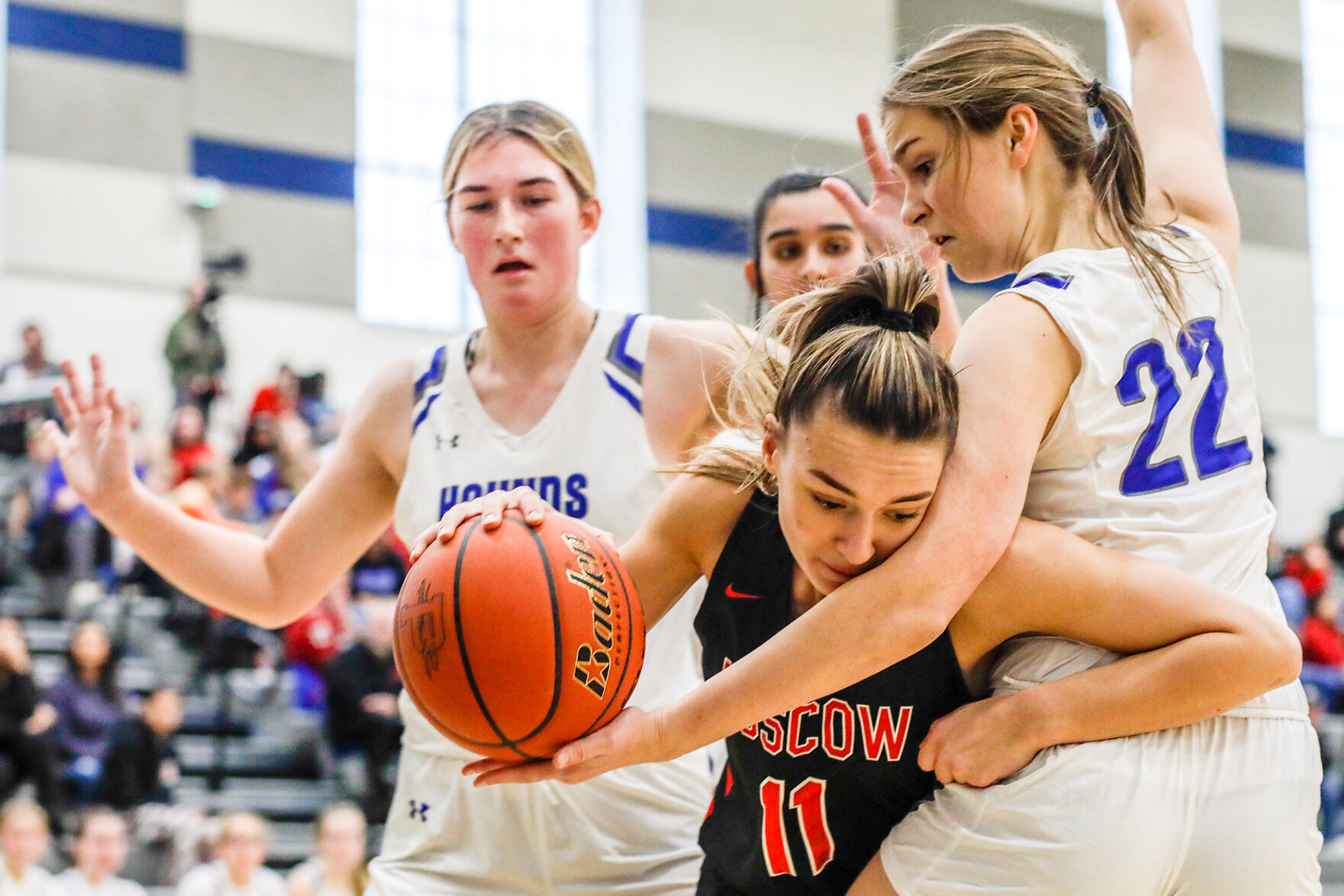 Moscow guard/forward Maya Anderson, center, fights to get around Pullman post Marissa Carper during Saturday's nonleague girls basketball game.