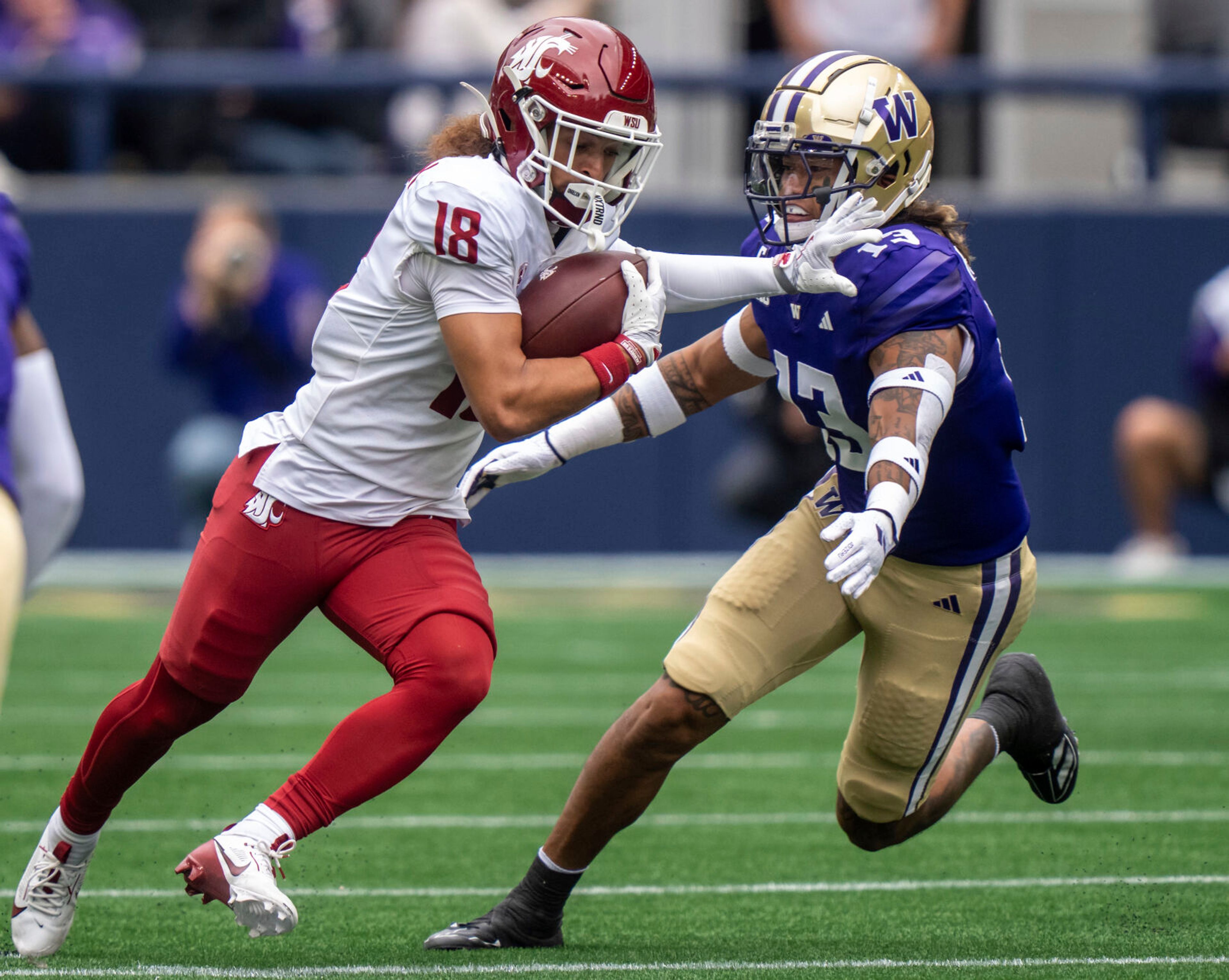 Washington State wide receiver Josh Meredith runs with the ball after making a catch against Washington defensive back Kamren Fabiculanan during the first half of an NCAA football game on Saturday, Sept. 14, 2024, in Seattle. (AP Photo/Stephen Brashear)