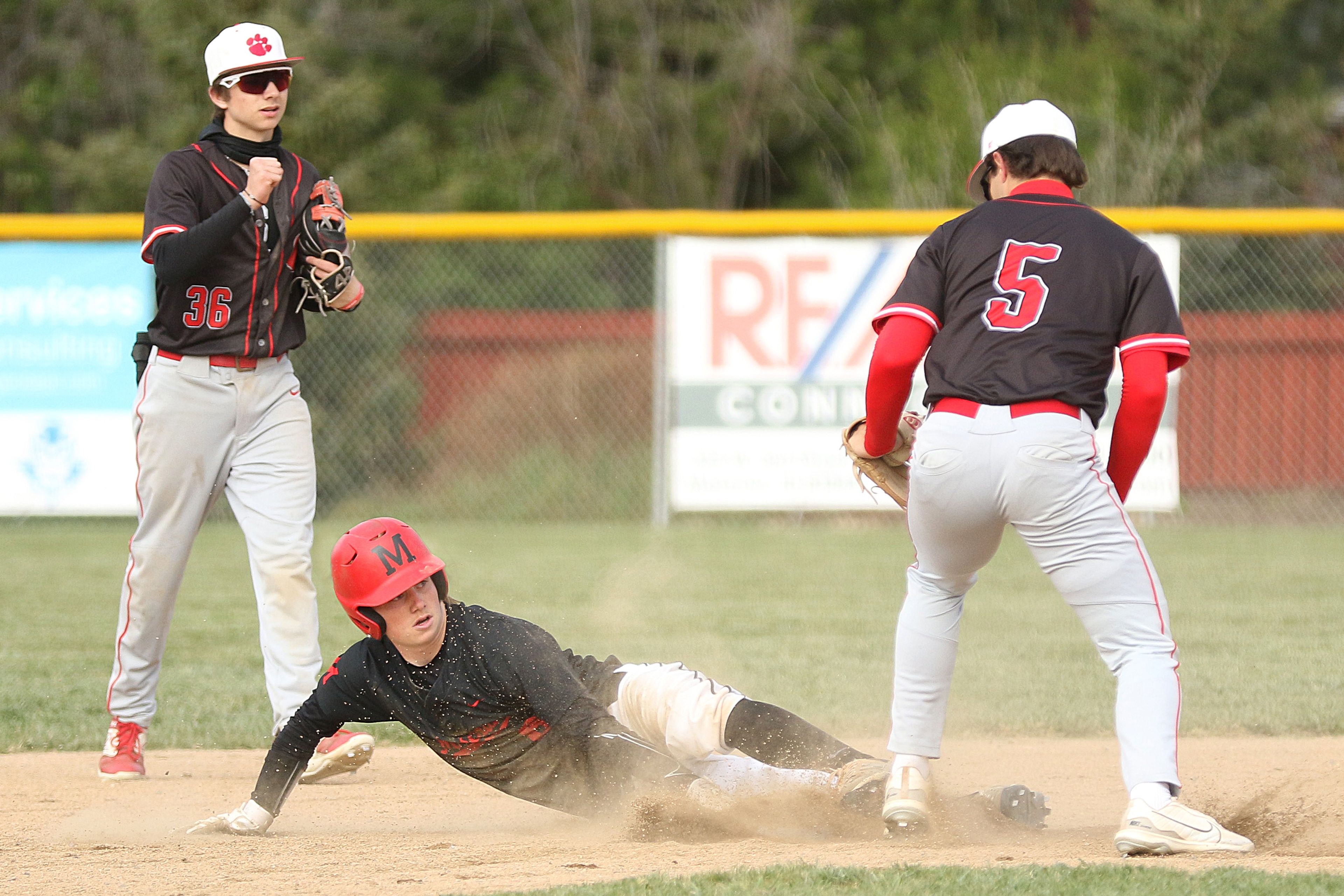 Moscow's Connor Isakson (center) steals second base during an Idaho Class 4A district championship against Sandpoint on Wednesday in Moscow.