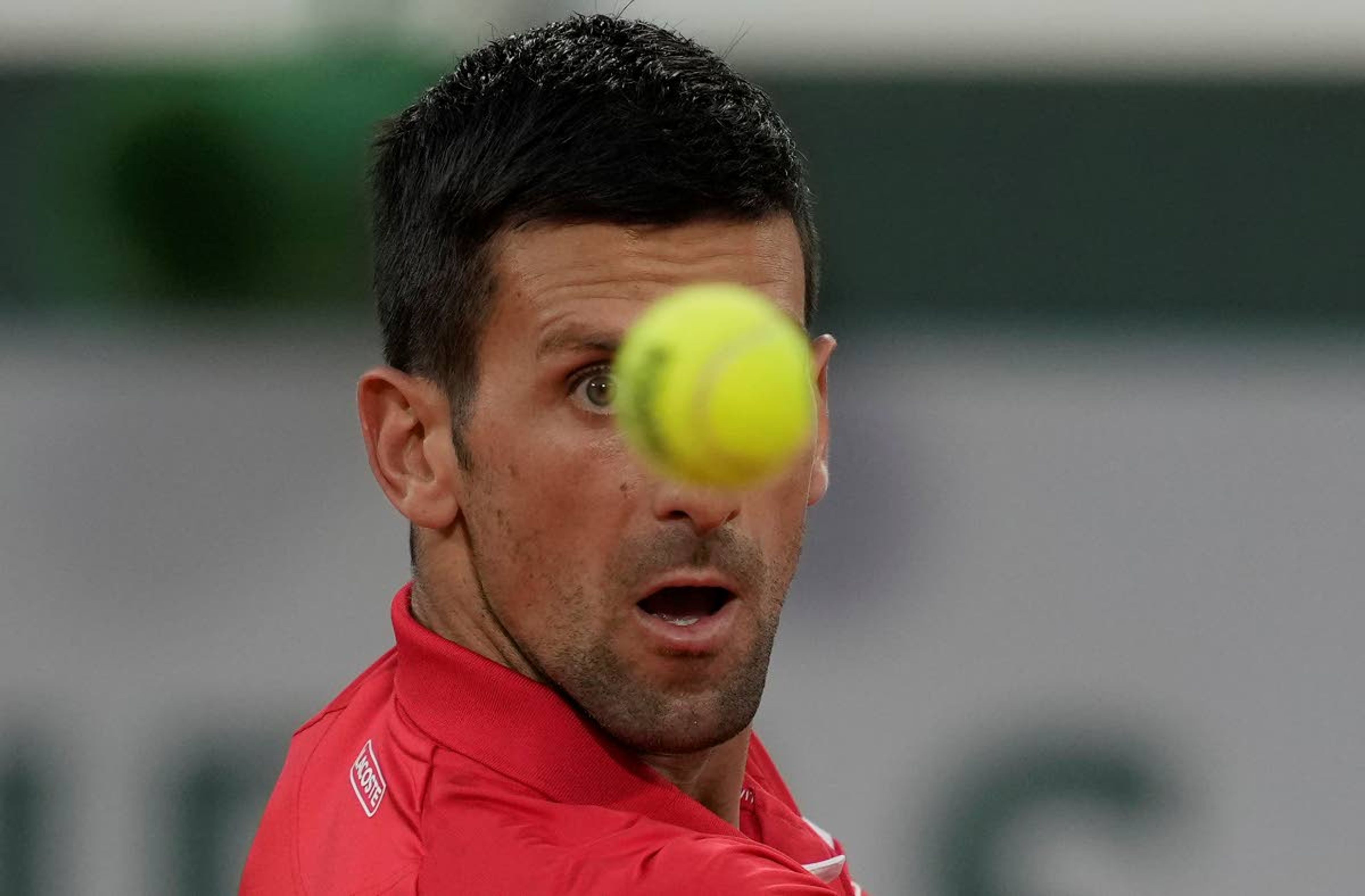 Serbia's Novak Djokovic plays a return to p United States's Tennys Sandgren during their first round match on day three of the French Open tennis tournament at Roland Garros in Paris, France, Tuesday, June 1, 2021. (AP Photo/Christophe Ena)