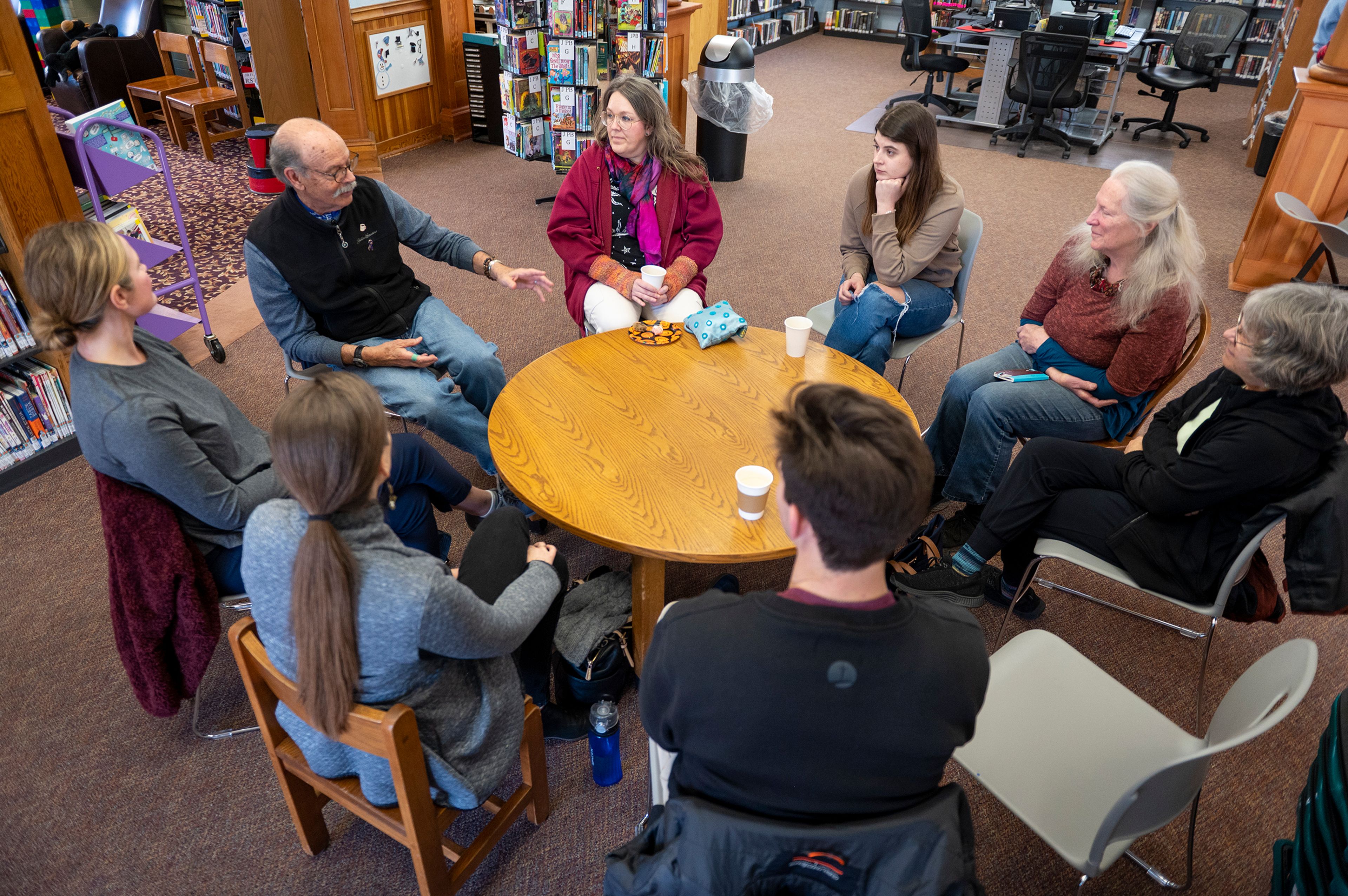 A small group discusses death during a Death Café at the Moscow Public Library on Tuesday.