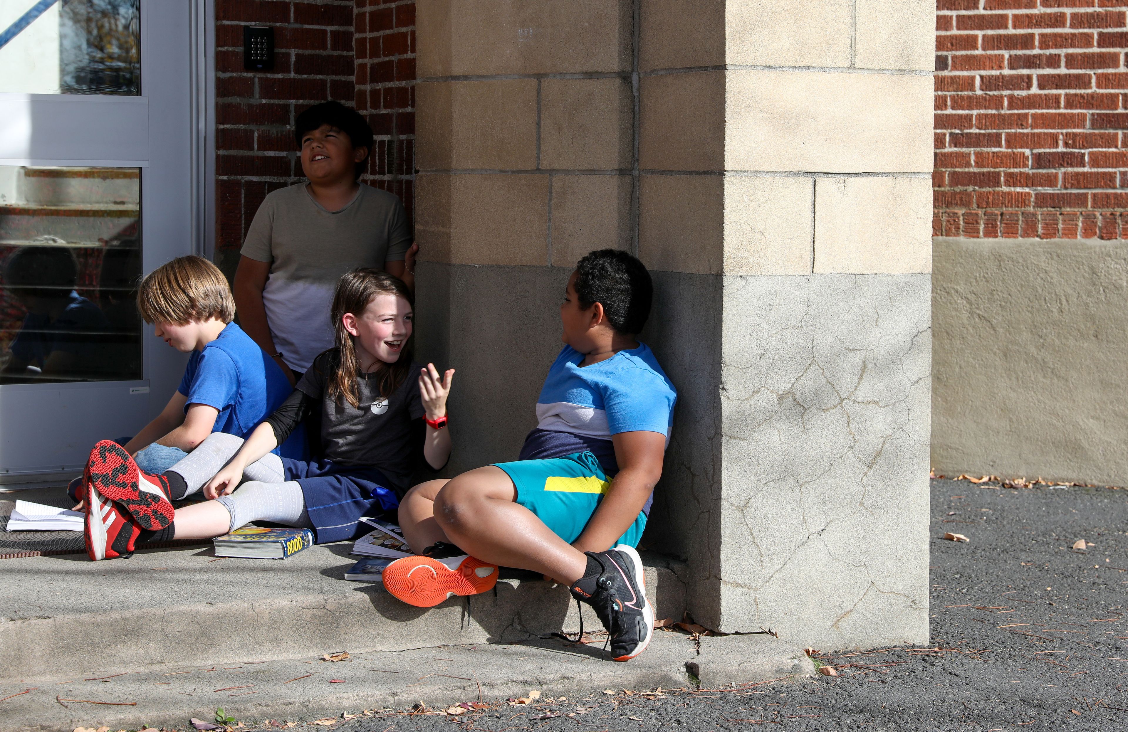 Fifth-grade students Grayson Bailey, center, and Khalid Aboubacar, right, talk about their principal’s upcoming stay at J. Russell Elementary School in Moscow. The students at the school raised more than $5,000 in a recent fundraiser, and their reward is for Principal Marianne Sletteland to spend a haunting Halloween night in the school.