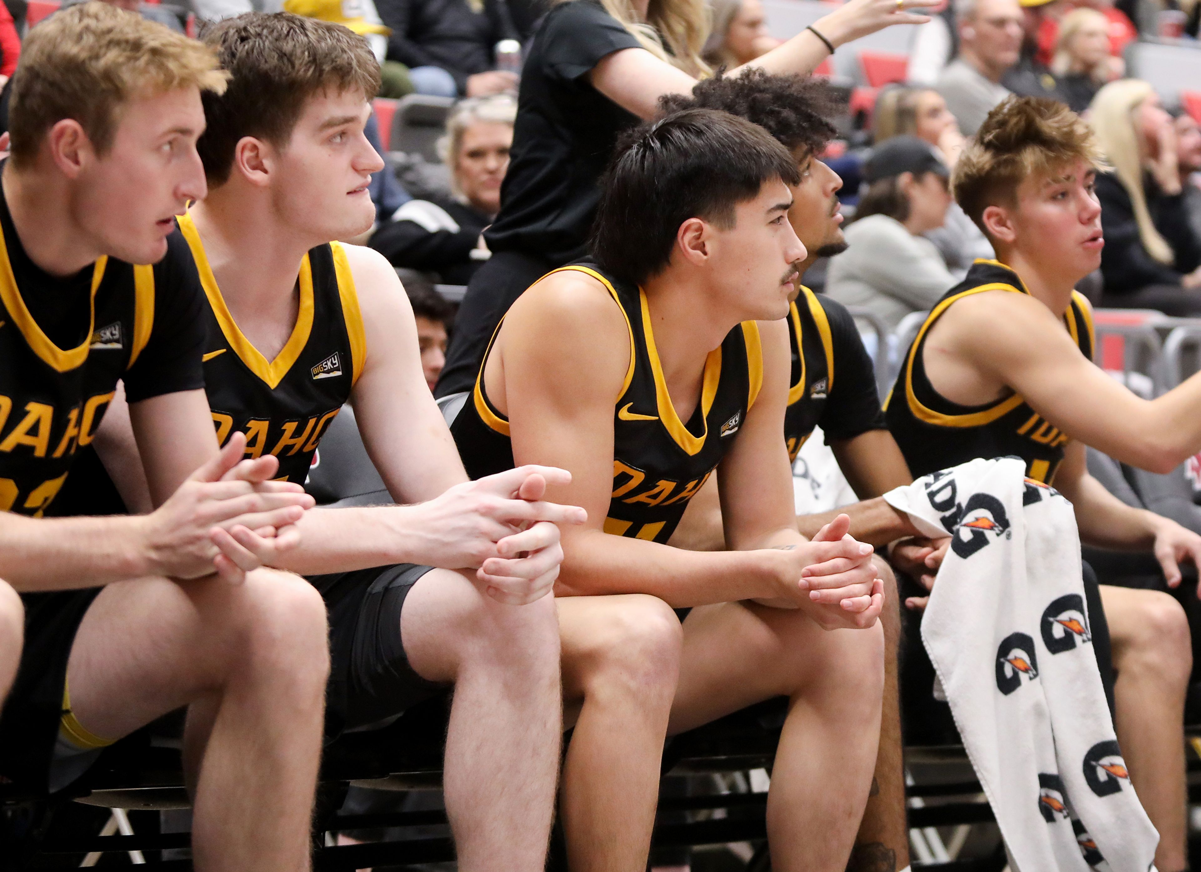 Idaho guard Titus Yearout, center, watches the game alongside teammates Monday during the Battle of the Palouse Monday at Beasley Coliseum in Pullman.