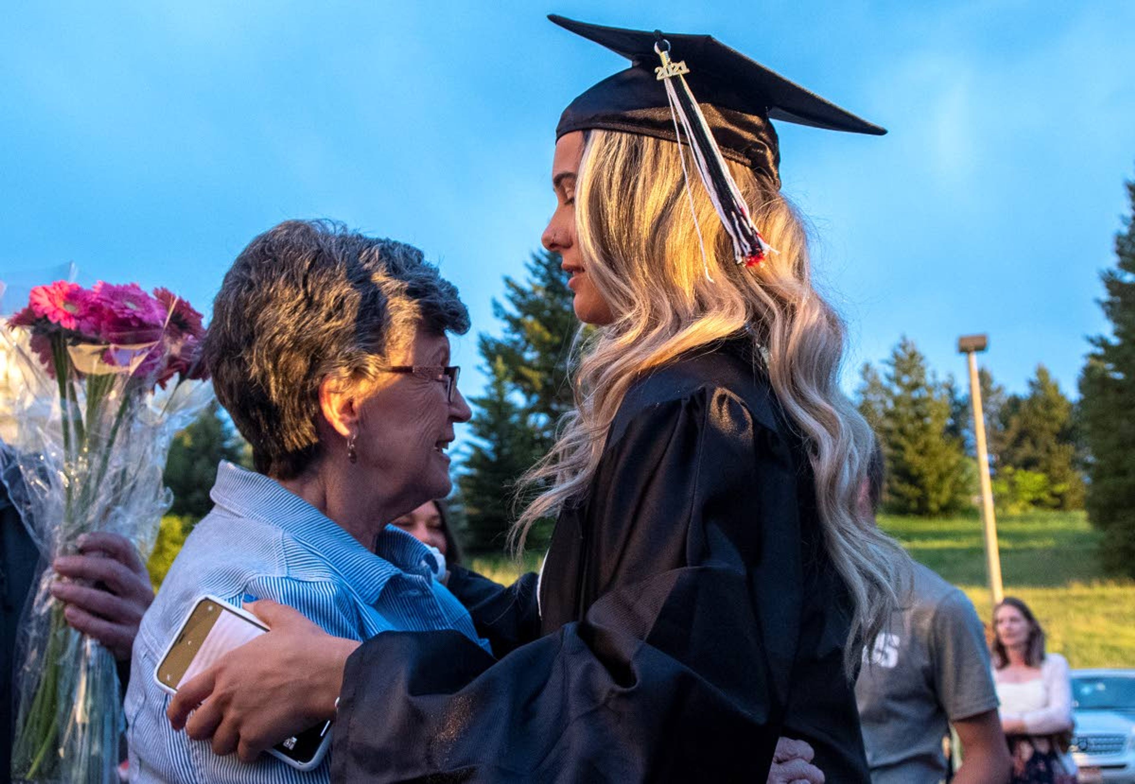 Graduate Sidnie Smith shares a moment with her grandmother, Mimi Smith, after completing Moscow High School’s Class of 2021 graduation commencement at the University of Idaho’s Kibbie Dome on Friday night.