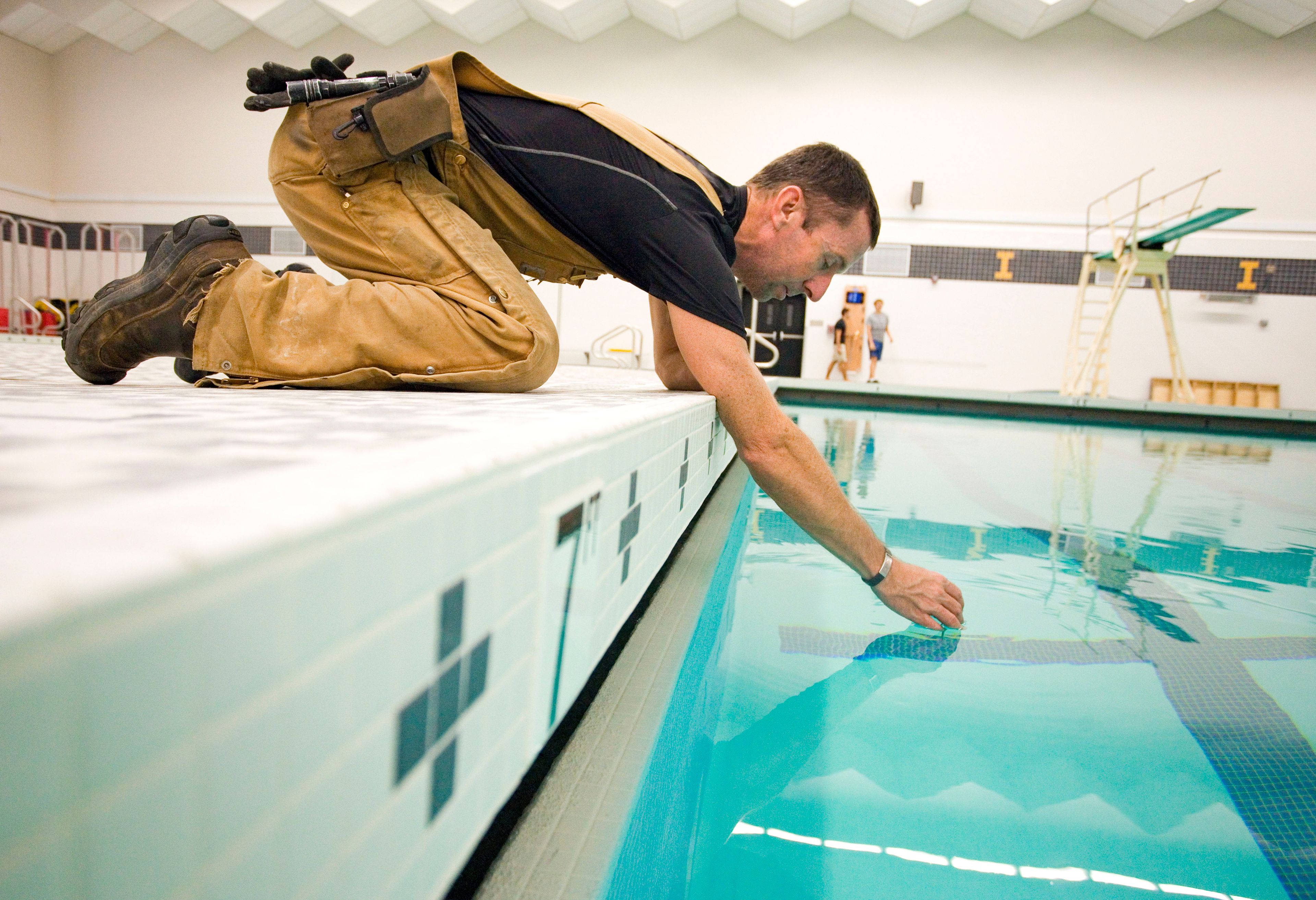 University of Idaho plumber Nate Spain checks the temperature of one of the pools at the UI Swim Center on Thursday in Moscow. The swim center is scheduled to open on Monday after being closed for the summer for a $1 million renovation that included replacing the ceramic tiles in both pools and part of the pool deck.